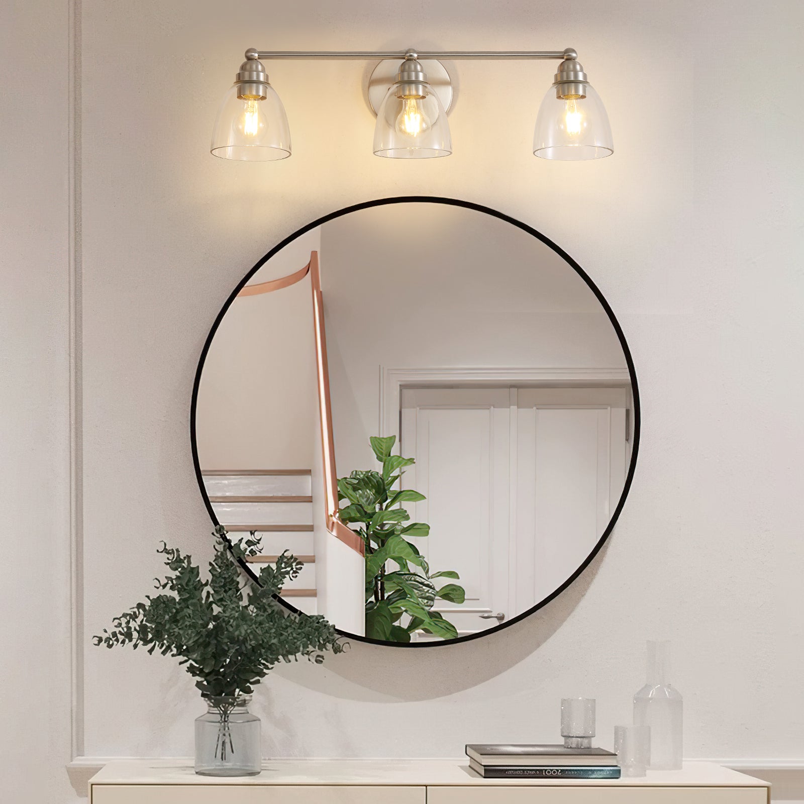 Brushed nickel vanity light with three clear glass bell shades