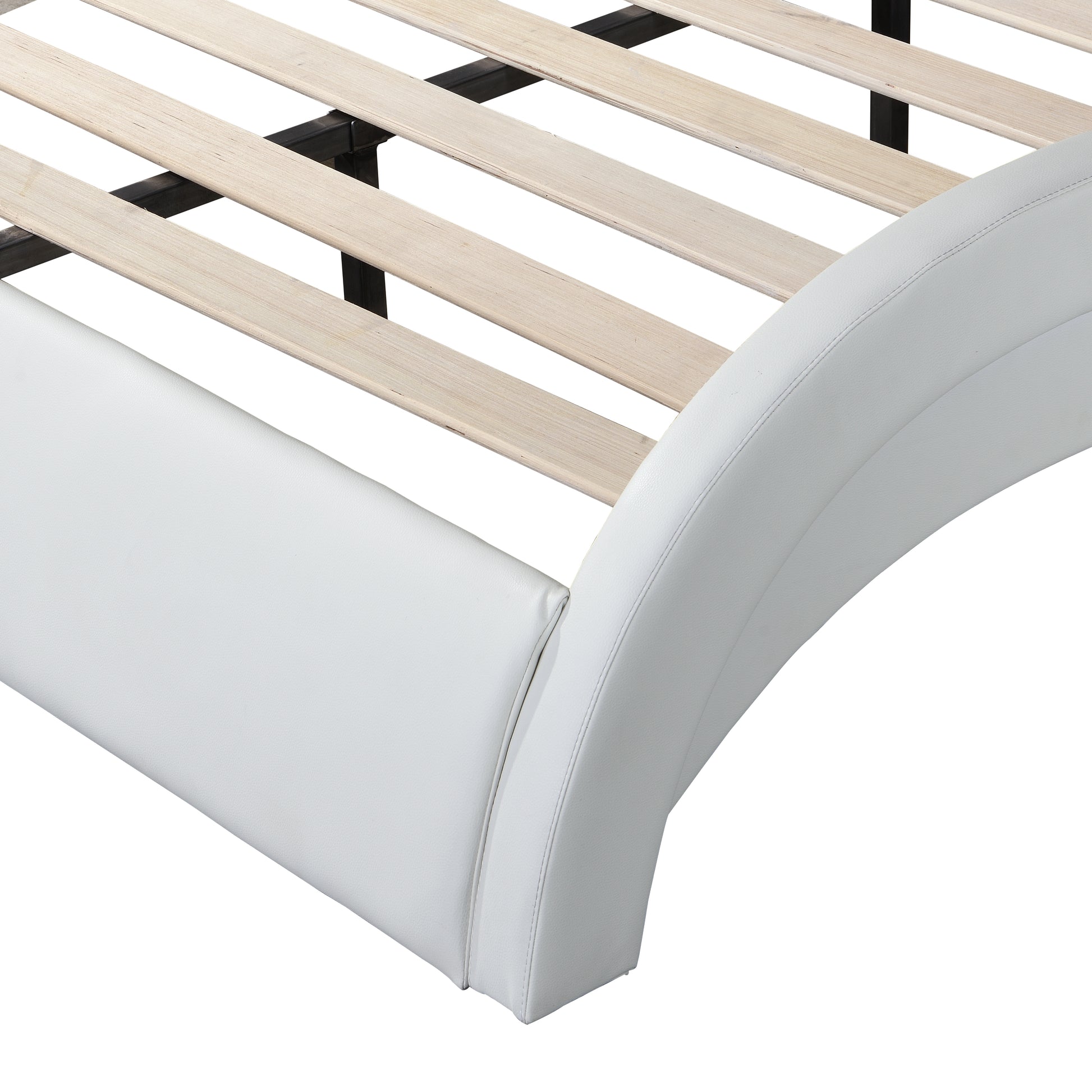 Closeup of white faux leather bed frame with curved headboard detail and wooden slats