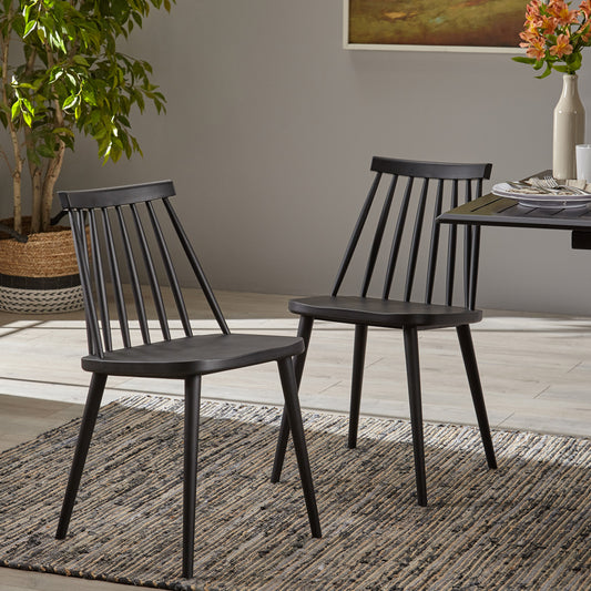 Two black spindle back dining chairs with tapered legs