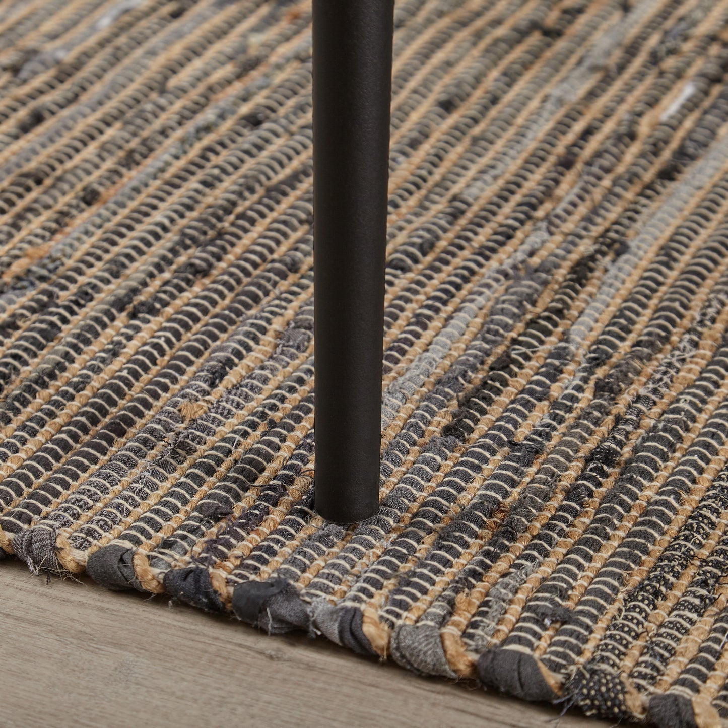 Woven natural fiber rug with gray and tan braided stripes