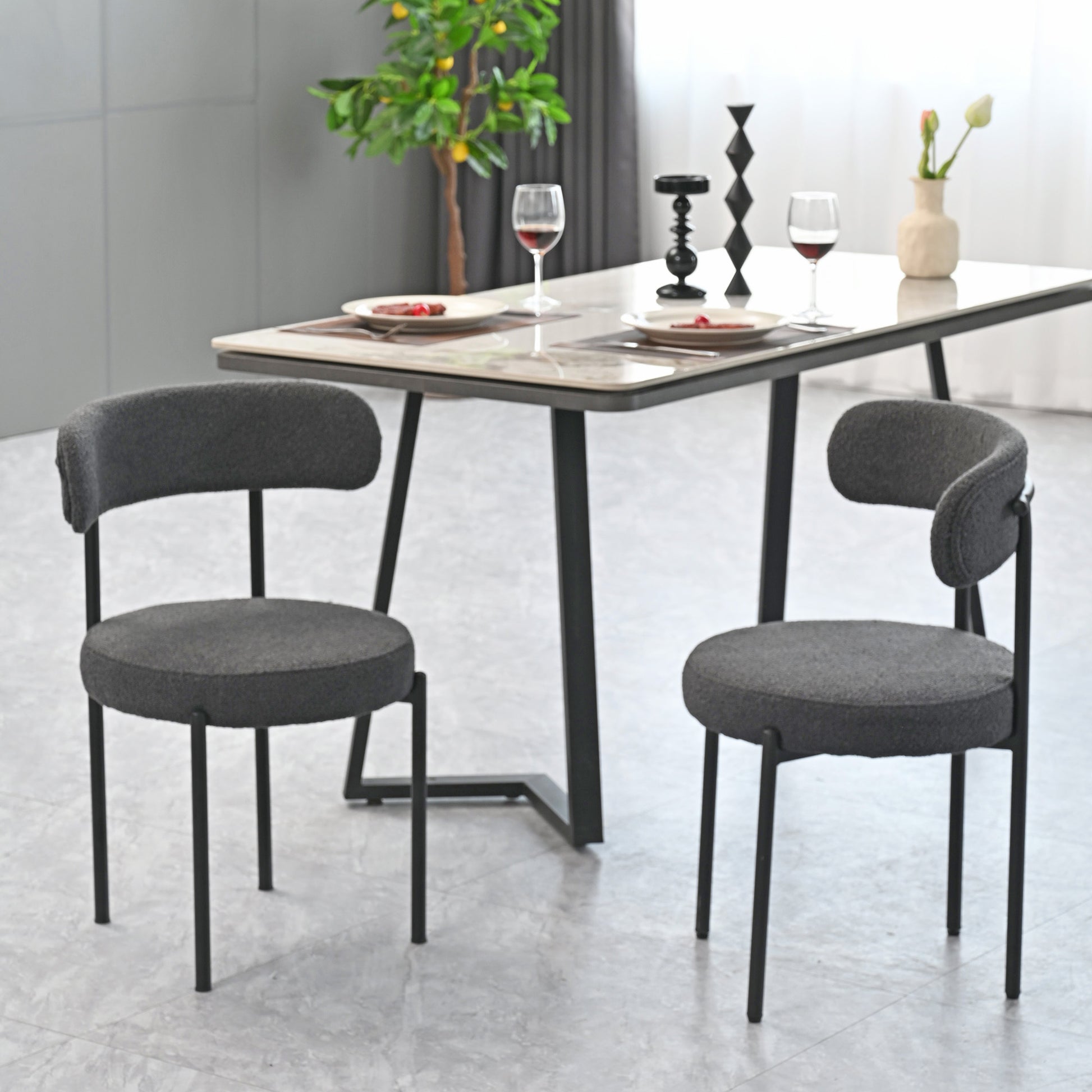 Dark grey upholstered dining chair with black metal legs