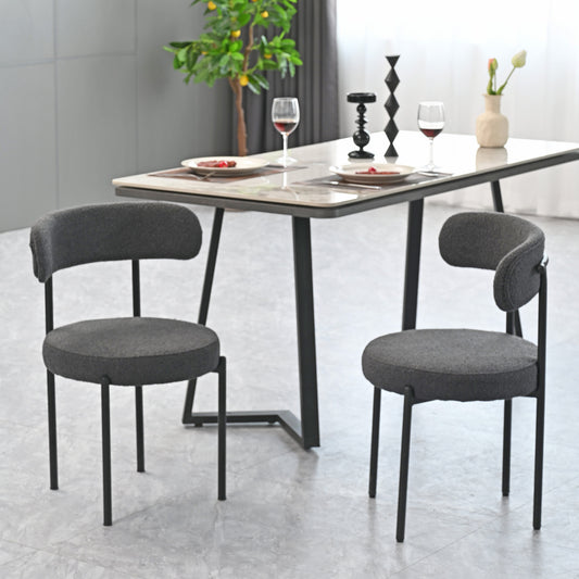Dark grey upholstered dining chair with black metal legs