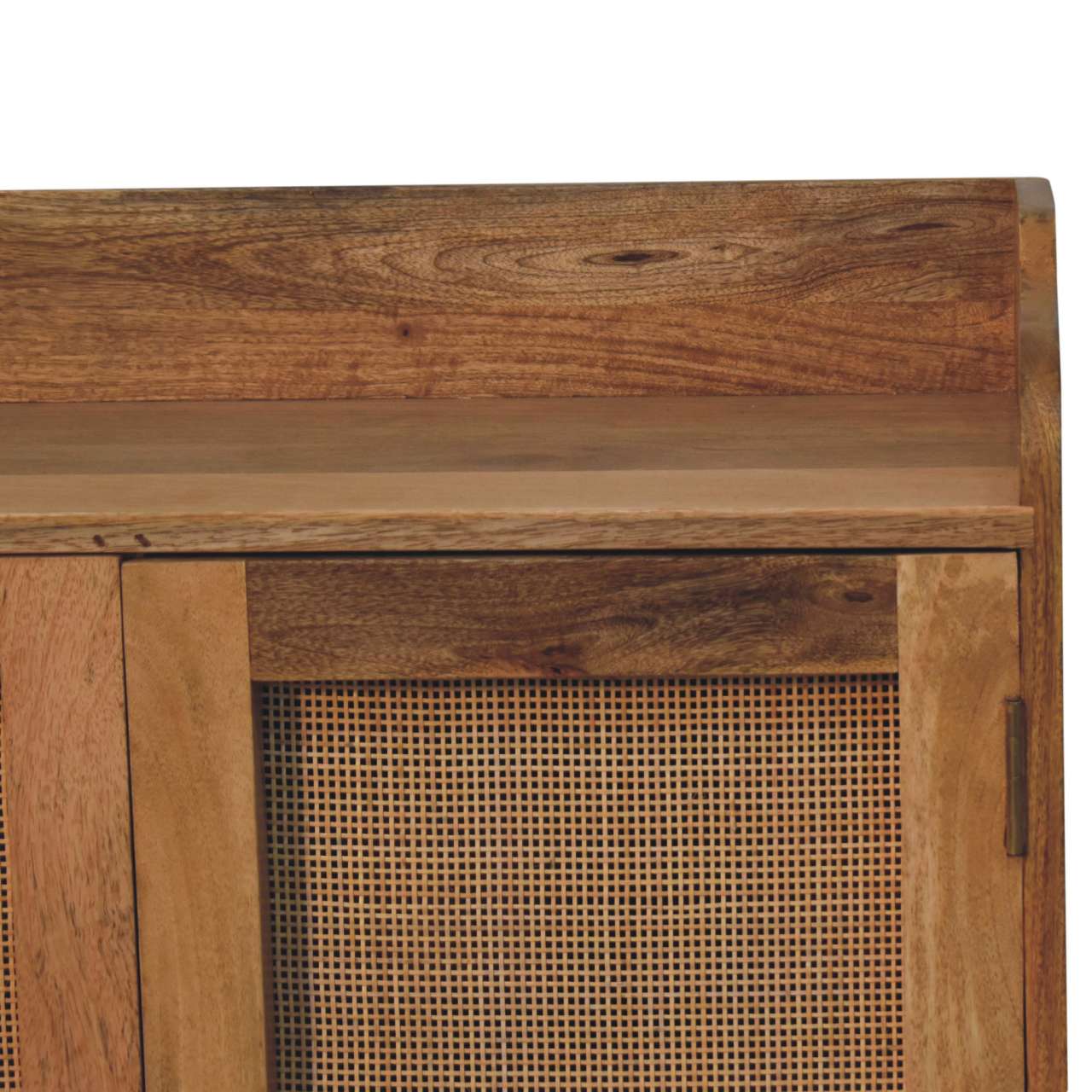 Closeup of natural wood cabinet with cane detailing