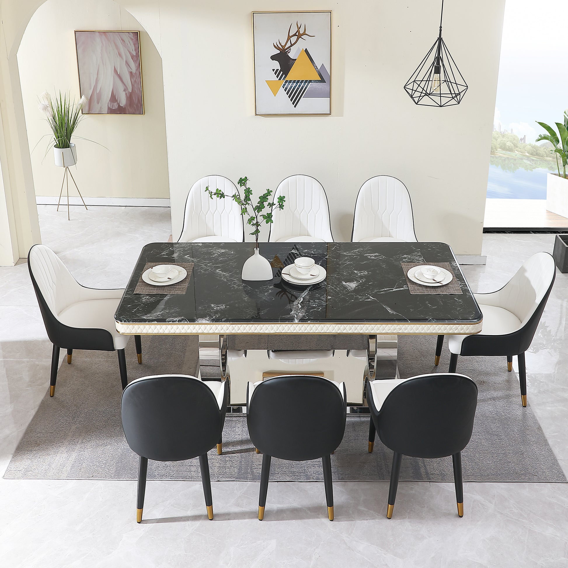 Black marble dining table with white and black chairs and a golden frame