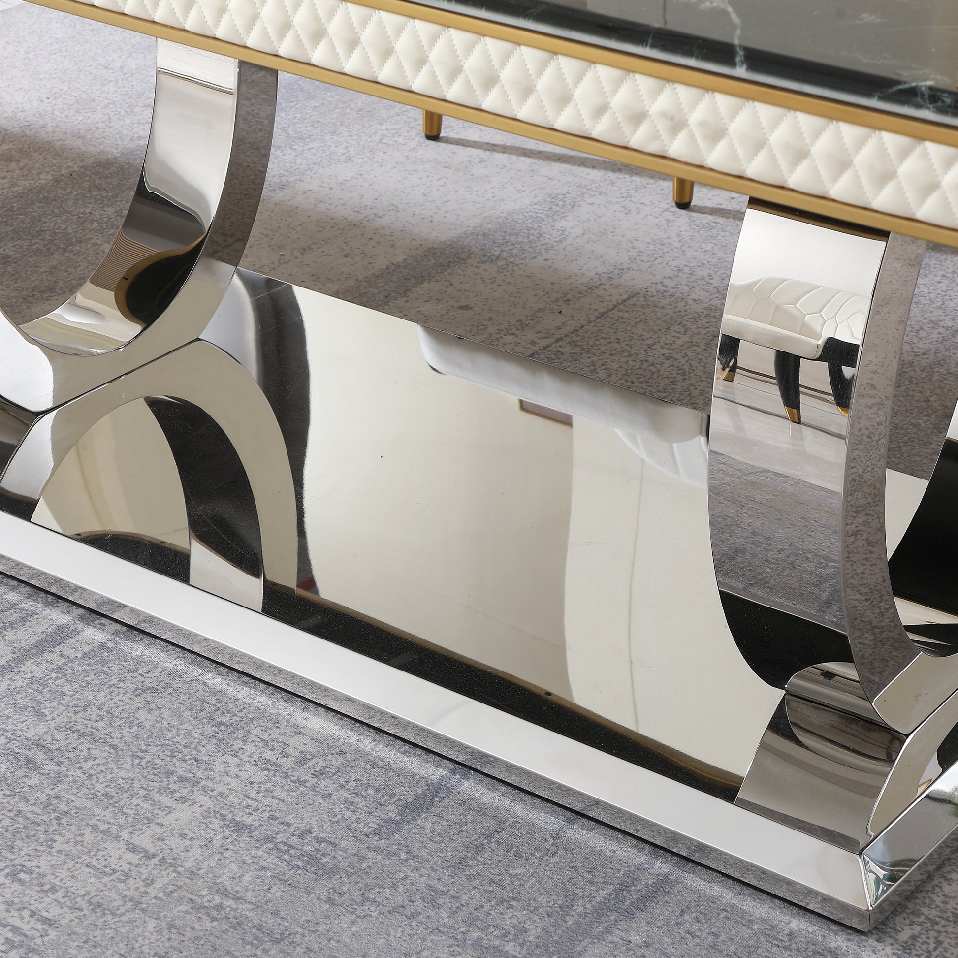 Reflective chrome legs of a modern coffee table