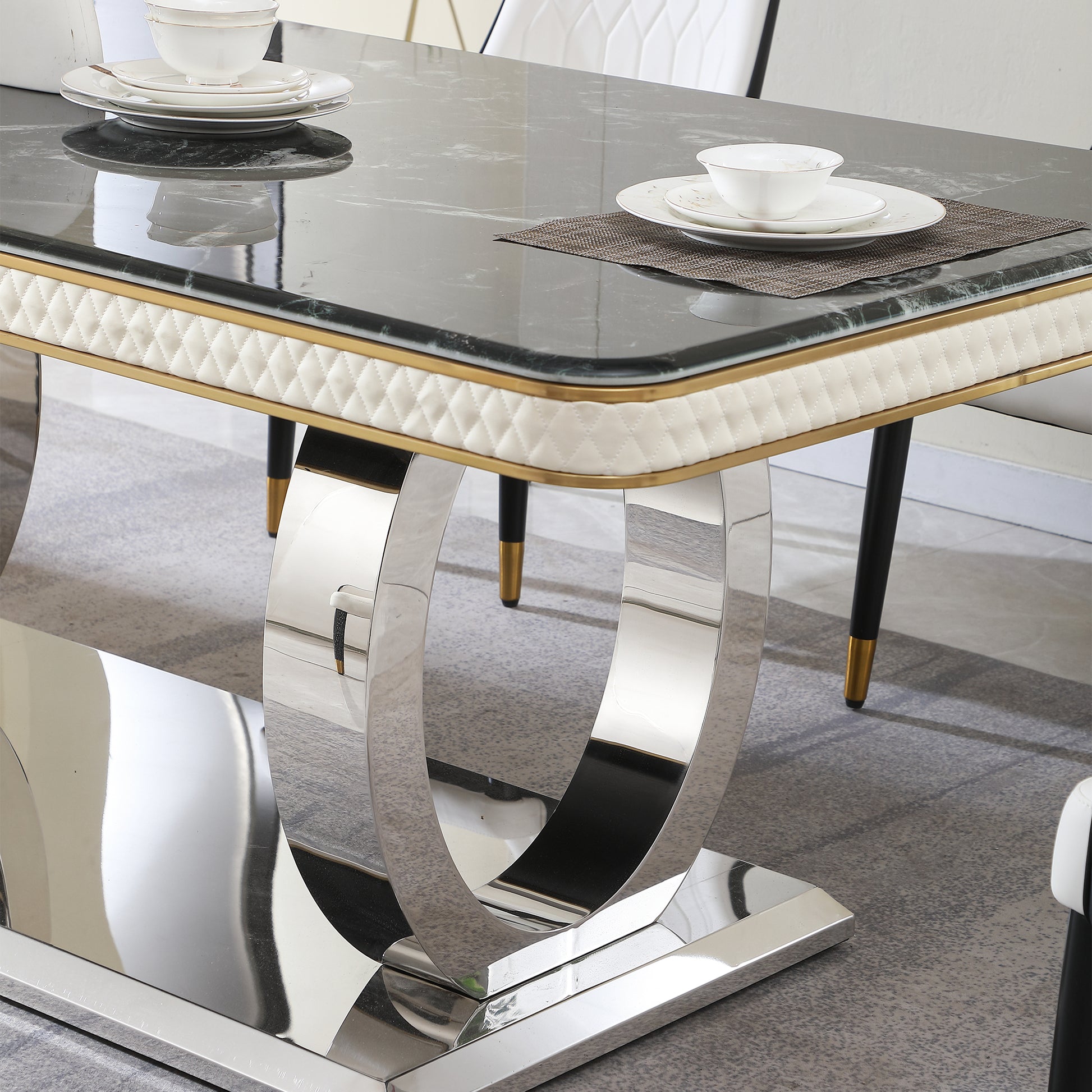 Elegant marble top dining table with a quilted ivory upholstered apron and gold trim