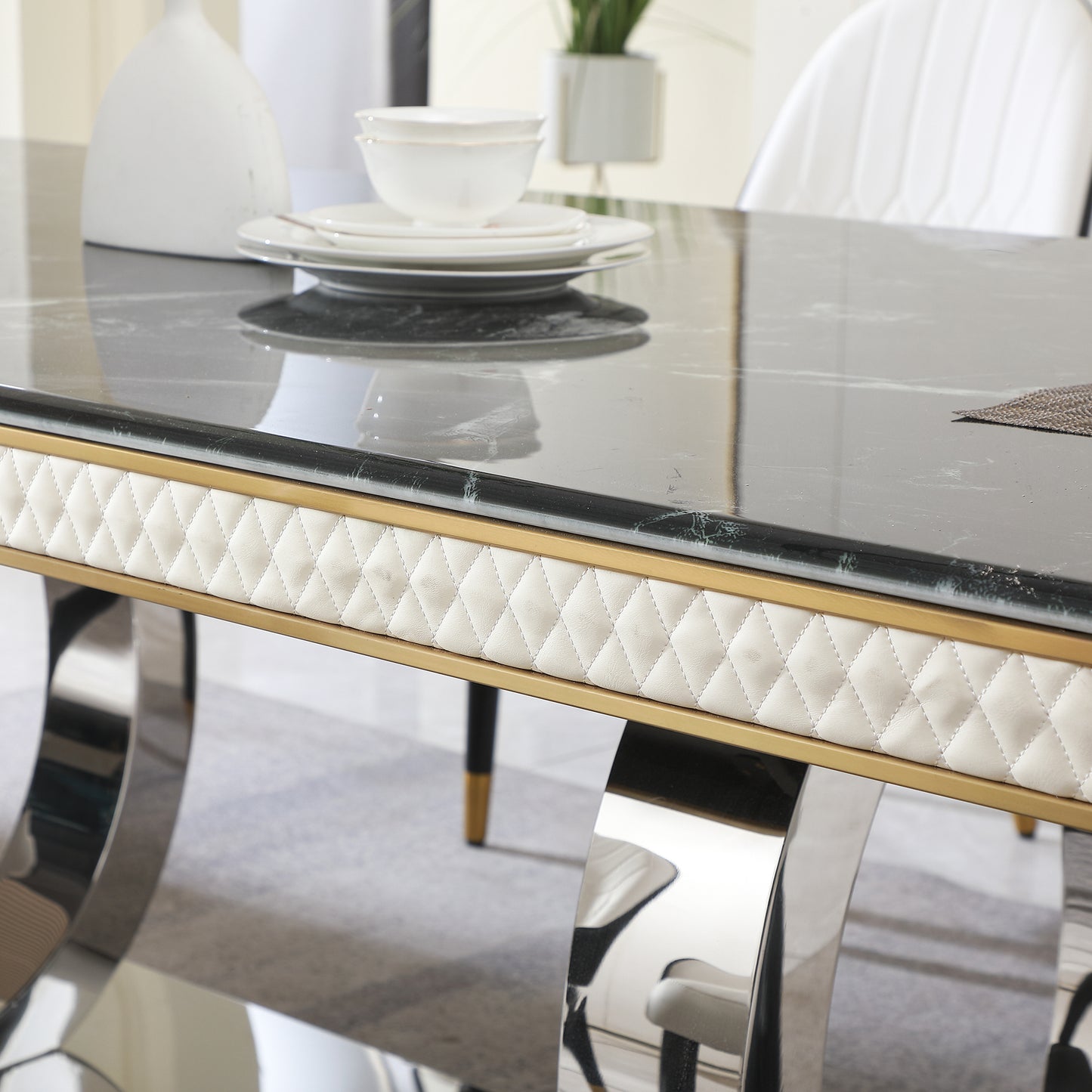 Luxury marble dining table with quilted cream upholstery and gold trim