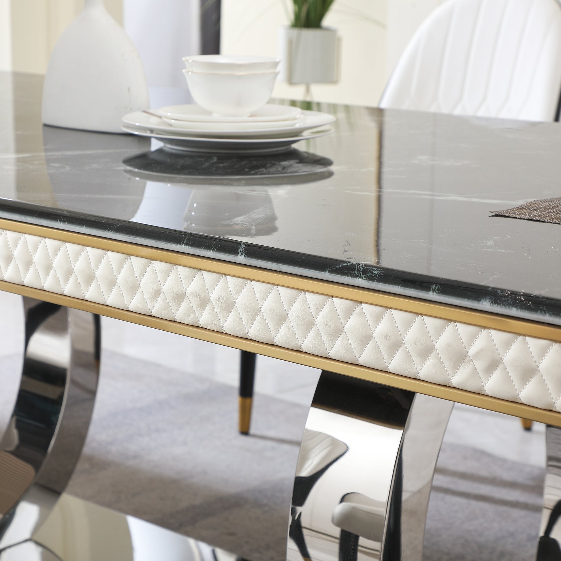 Luxury marble dining table with quilted cream upholstery and gold trim