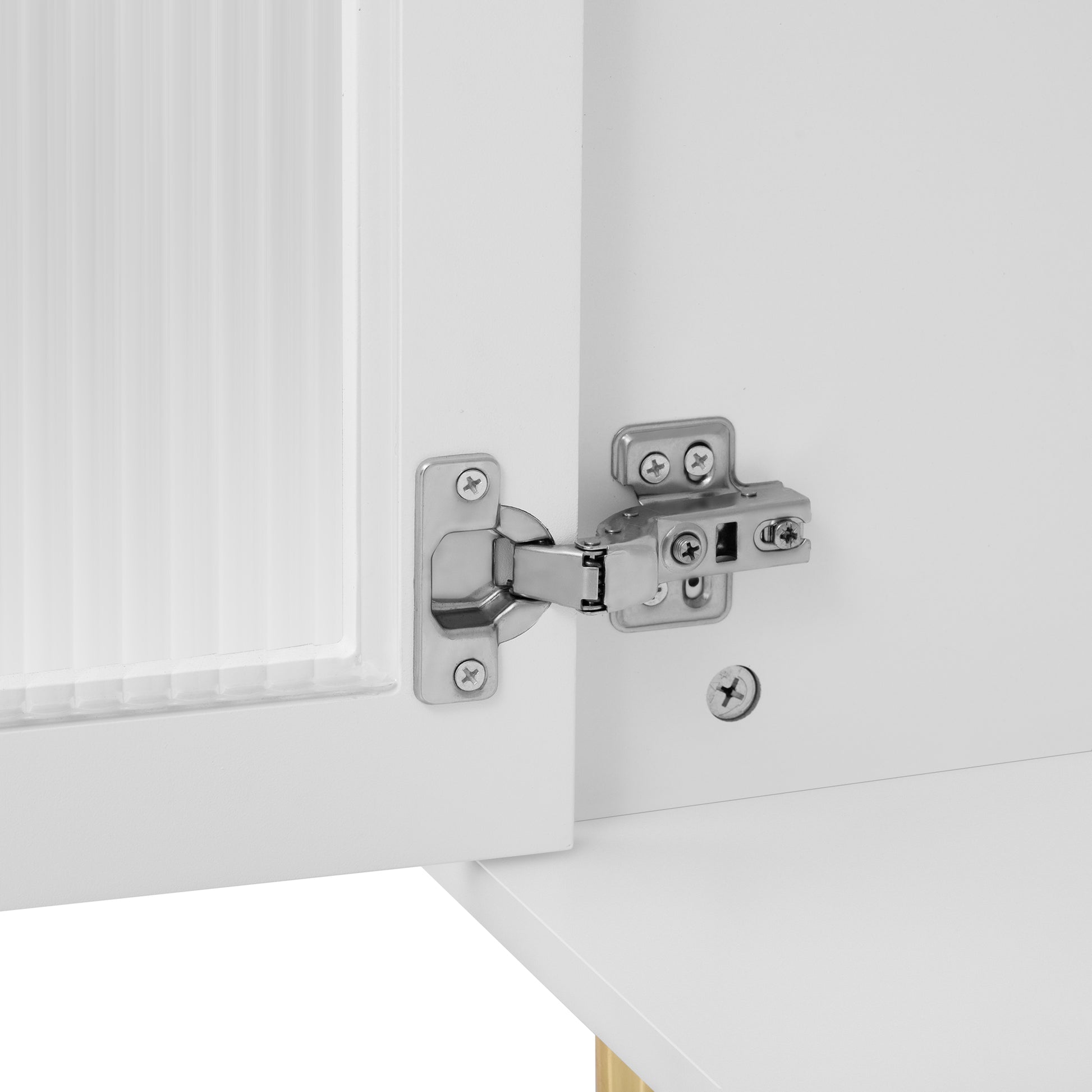Closeup of brushed nickel cabinet hinge on white overlay door