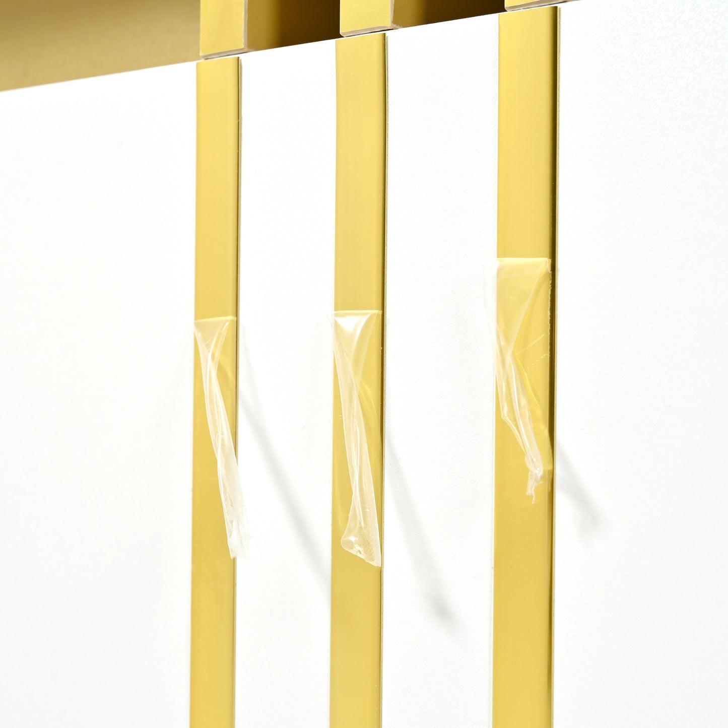 Closeup of a modern white cabinet door with gold vertical accents