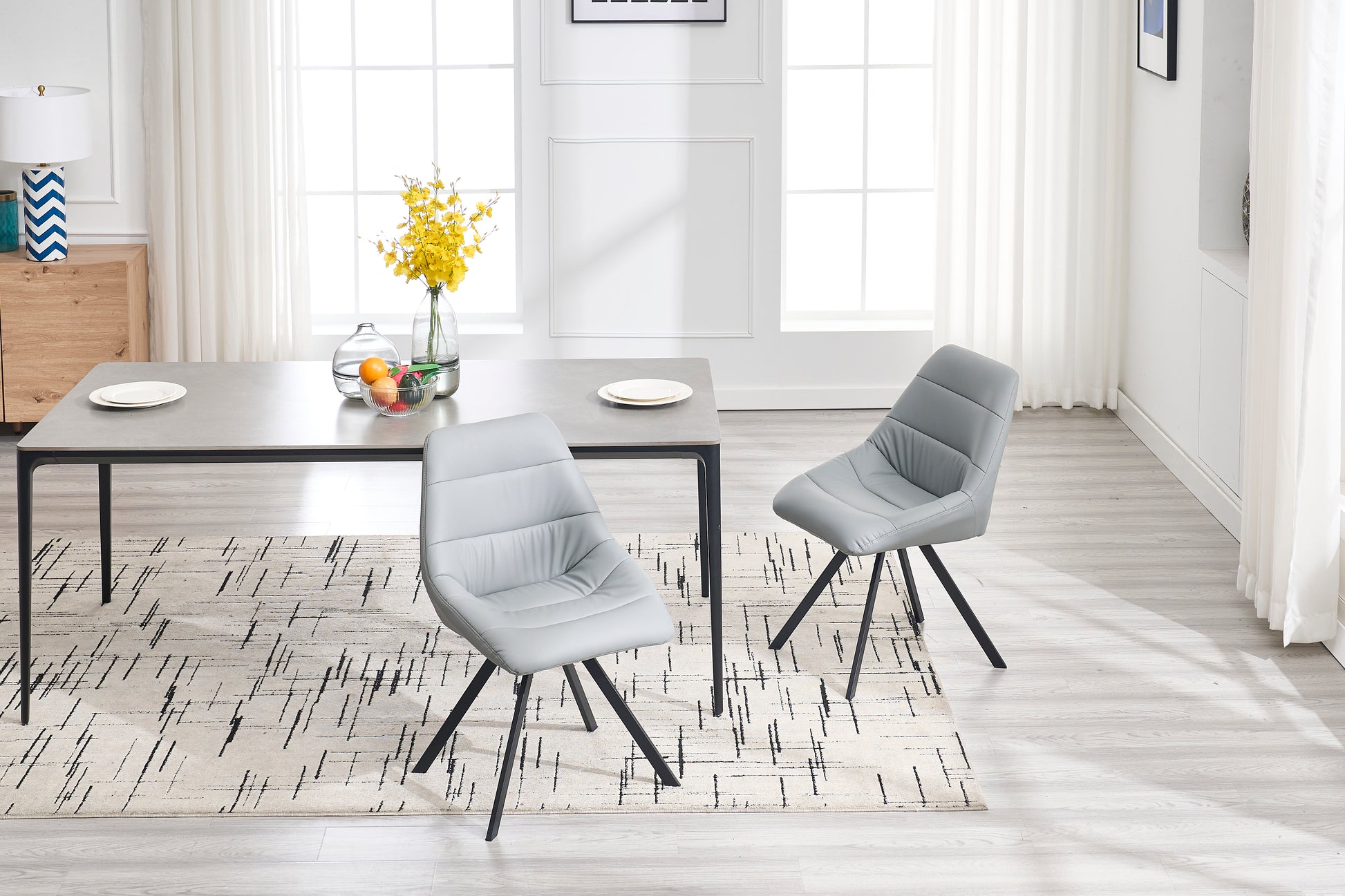Stylish light gray faux leather dining chair with stitched detailing and black metal legs