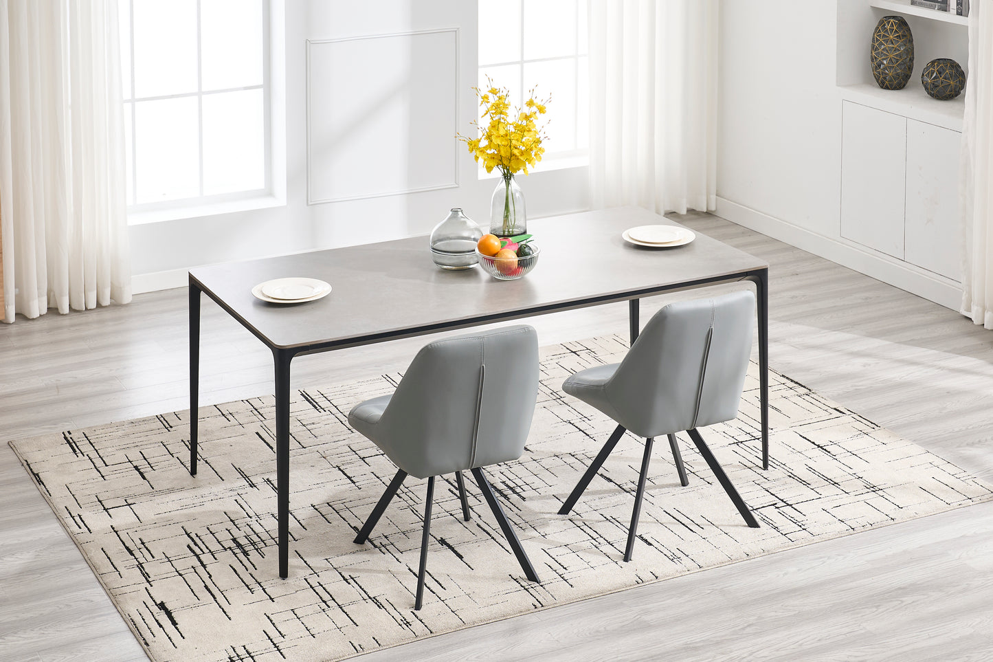 Modern grey dining table with minimalist black legs and grey upholstered chairs