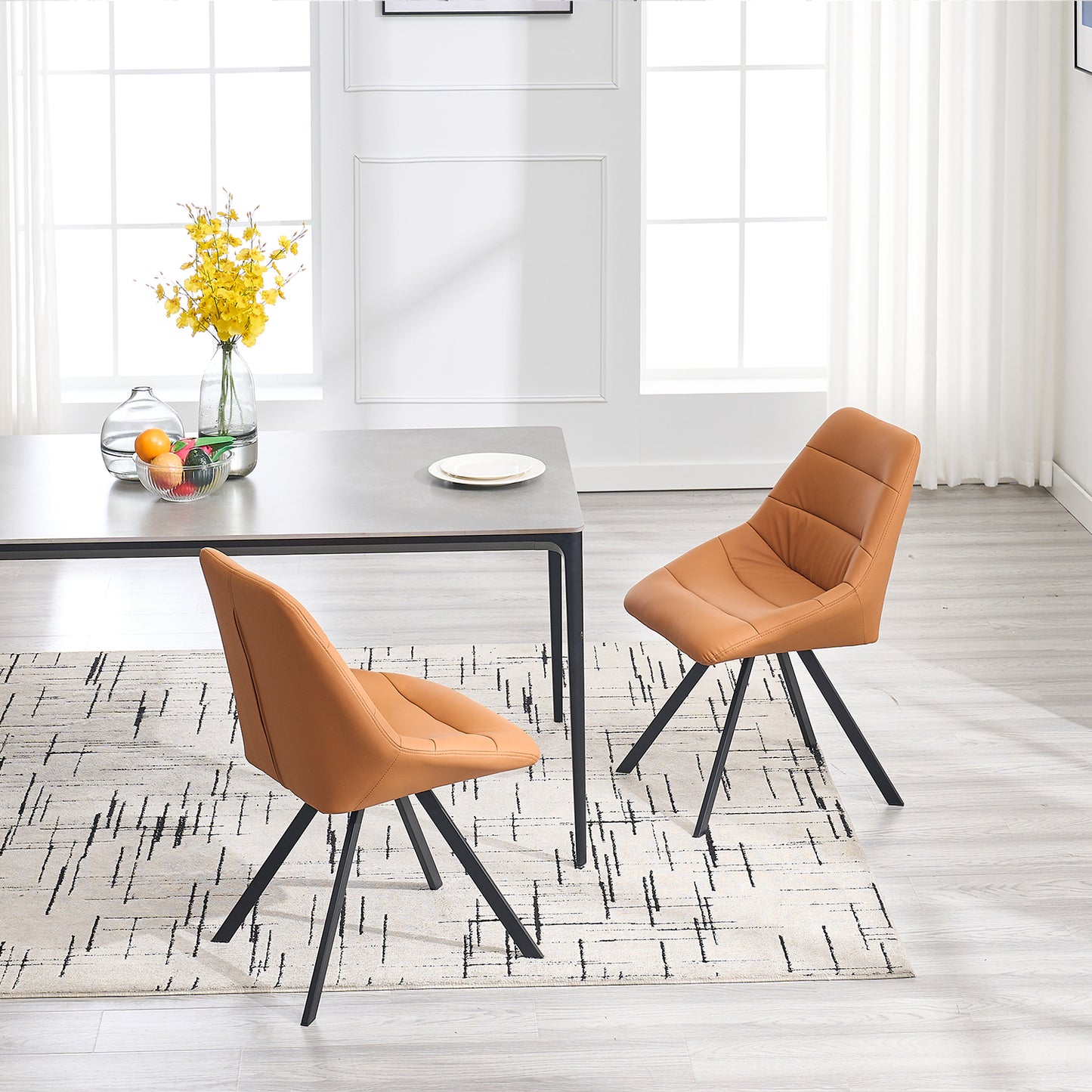 Tan upholstered dining chair with stitched detailing and black metal legs