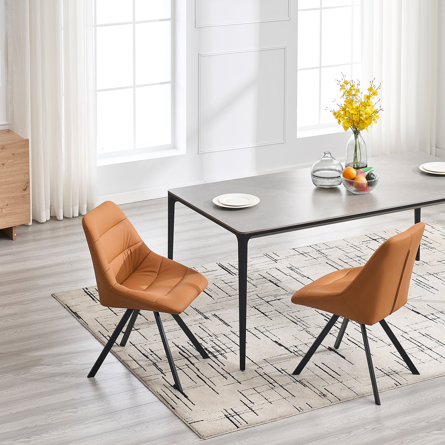 Tan upholstered dining chair with black metal legs