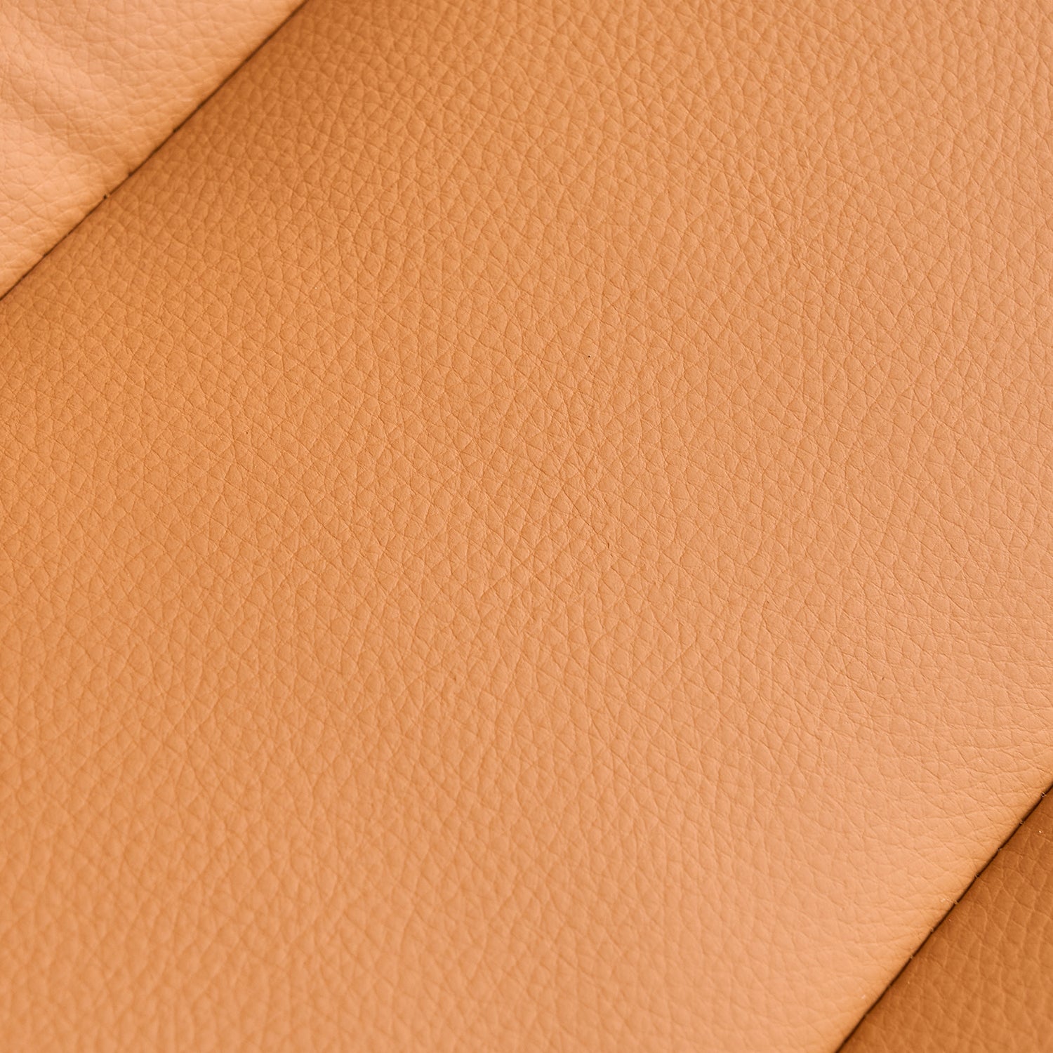 Closeup of textured tan genuine leather upholstery