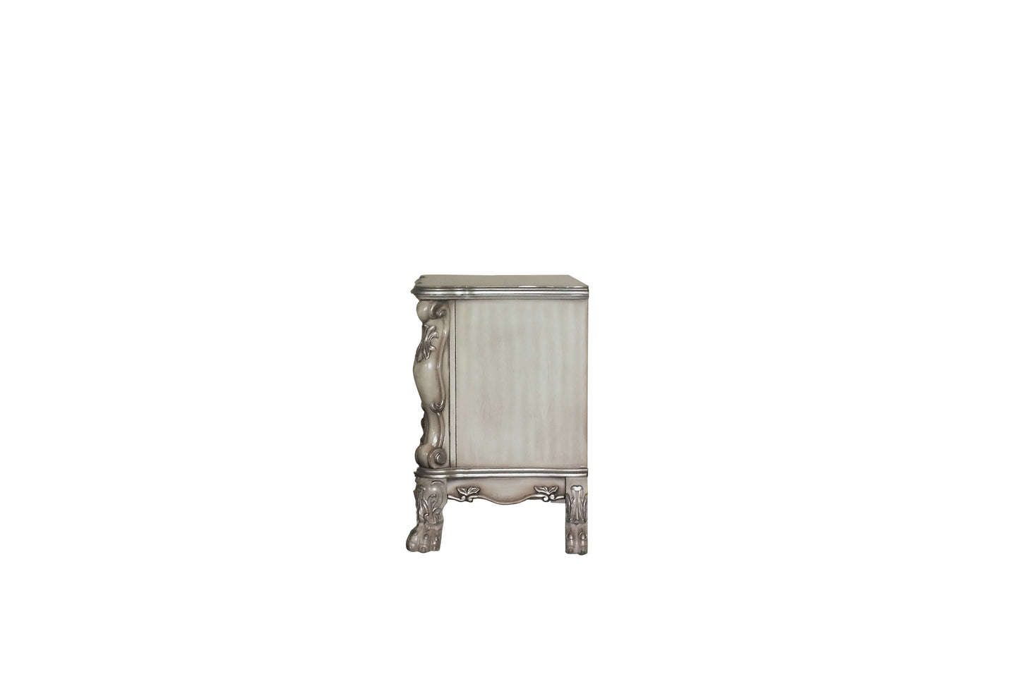 Ornate antique dresser with carved details and silver accents