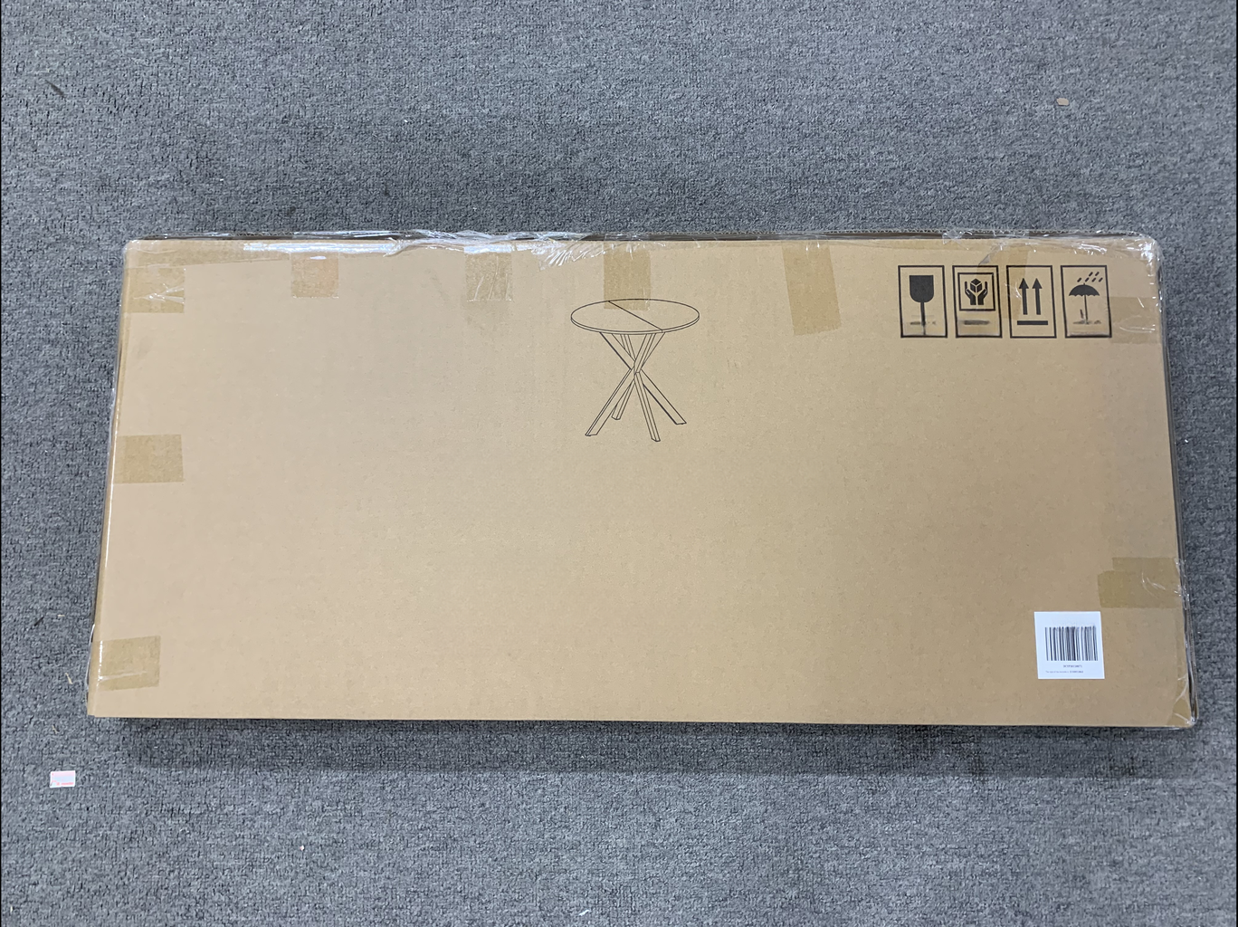 Cardboard box with outline of round folding table on top