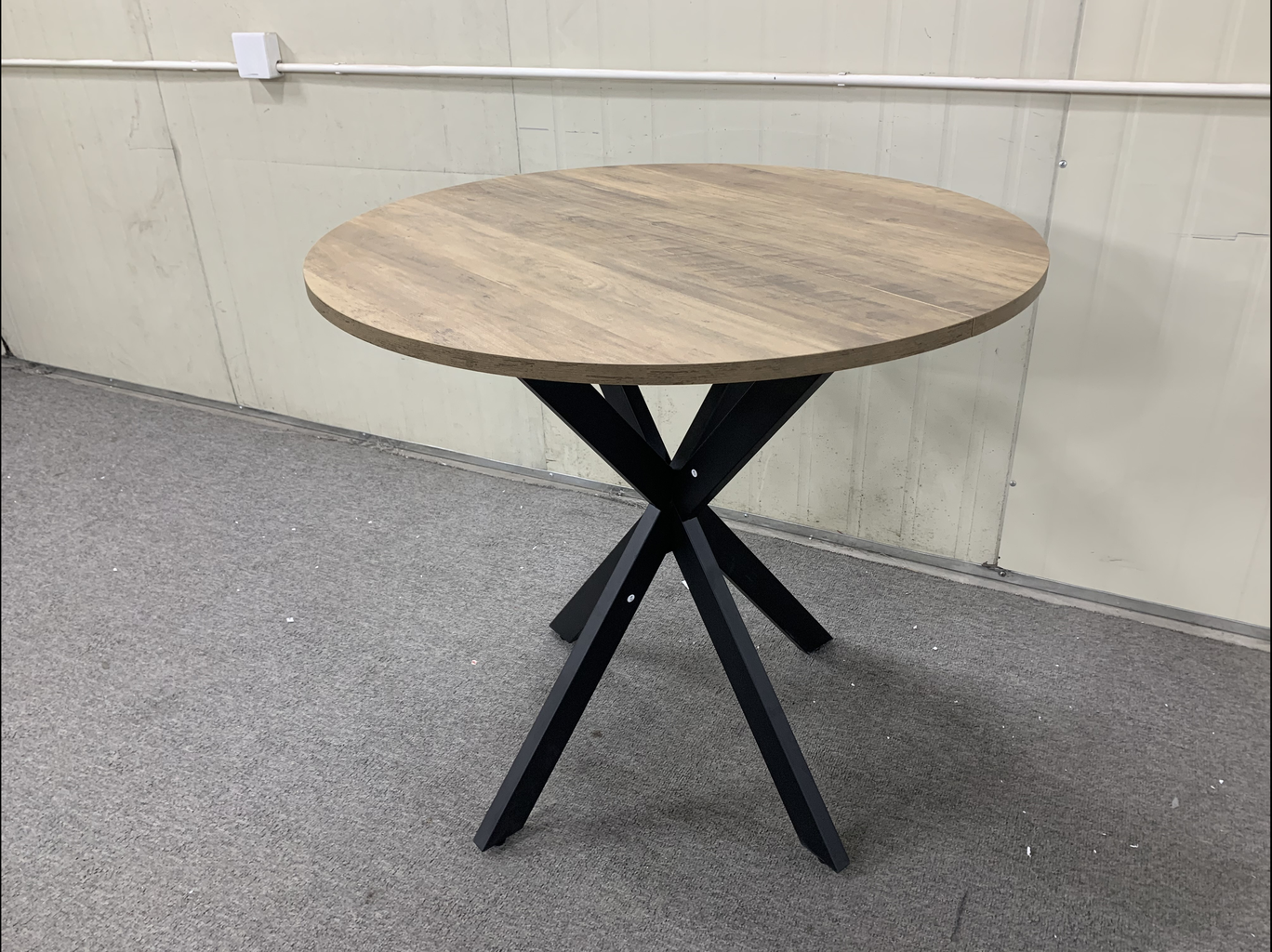 Round wood grain top accent table with black metal spider leg base