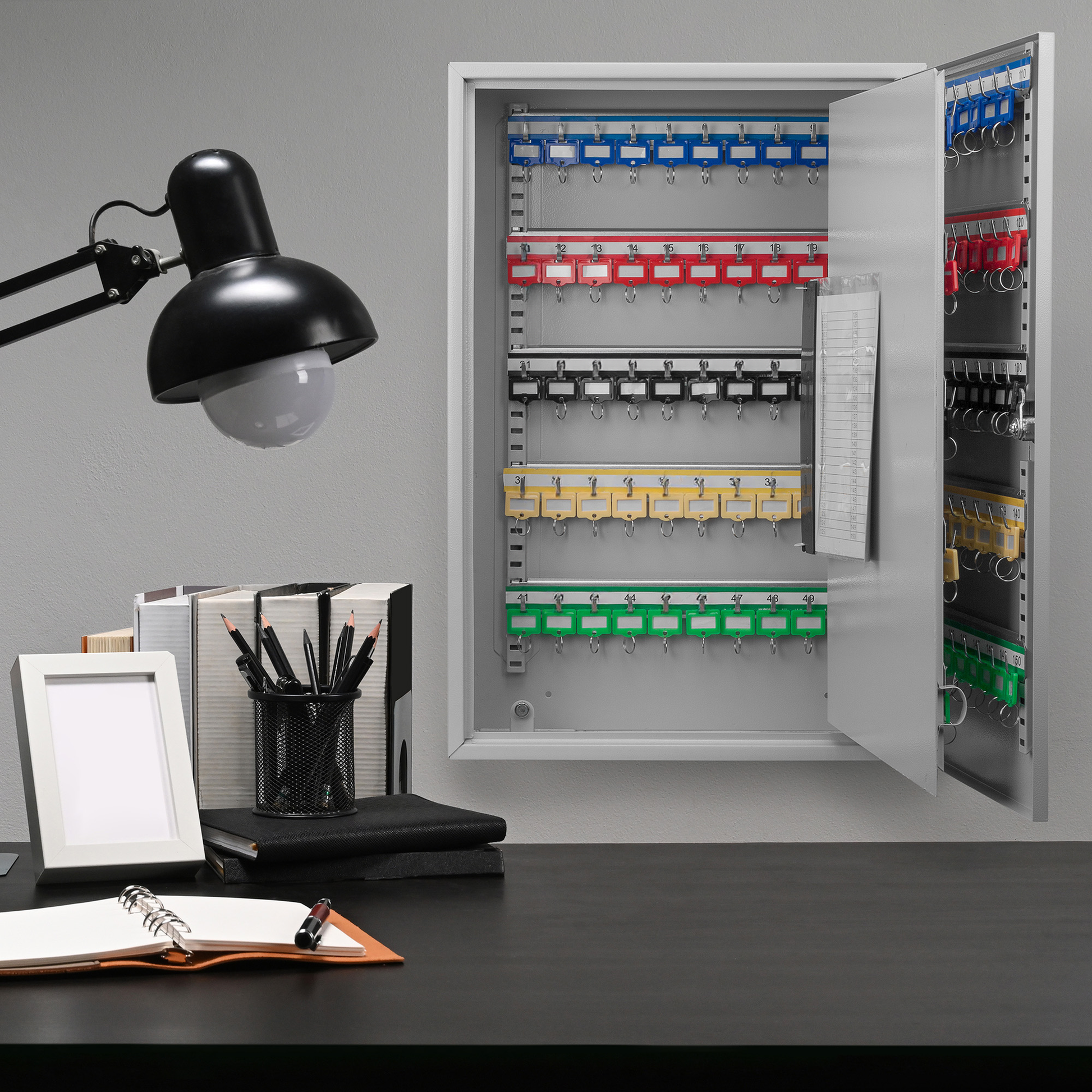 metal key cabinet with  numbered slots and colorcoded key tags for organization