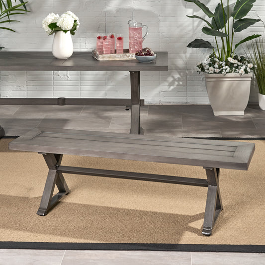 Gray wooden outdoor bench with slatted seat and Xshaped legs