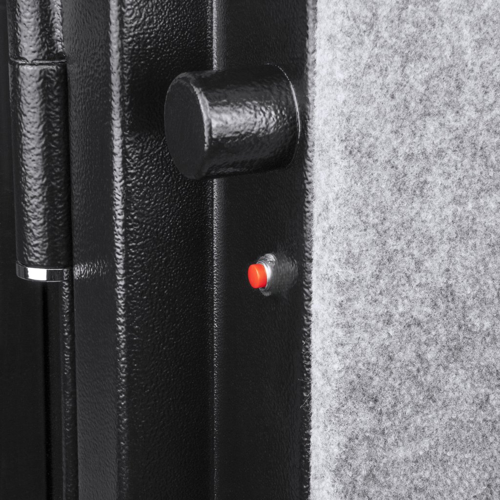 Black steel gun safe door detail with red button