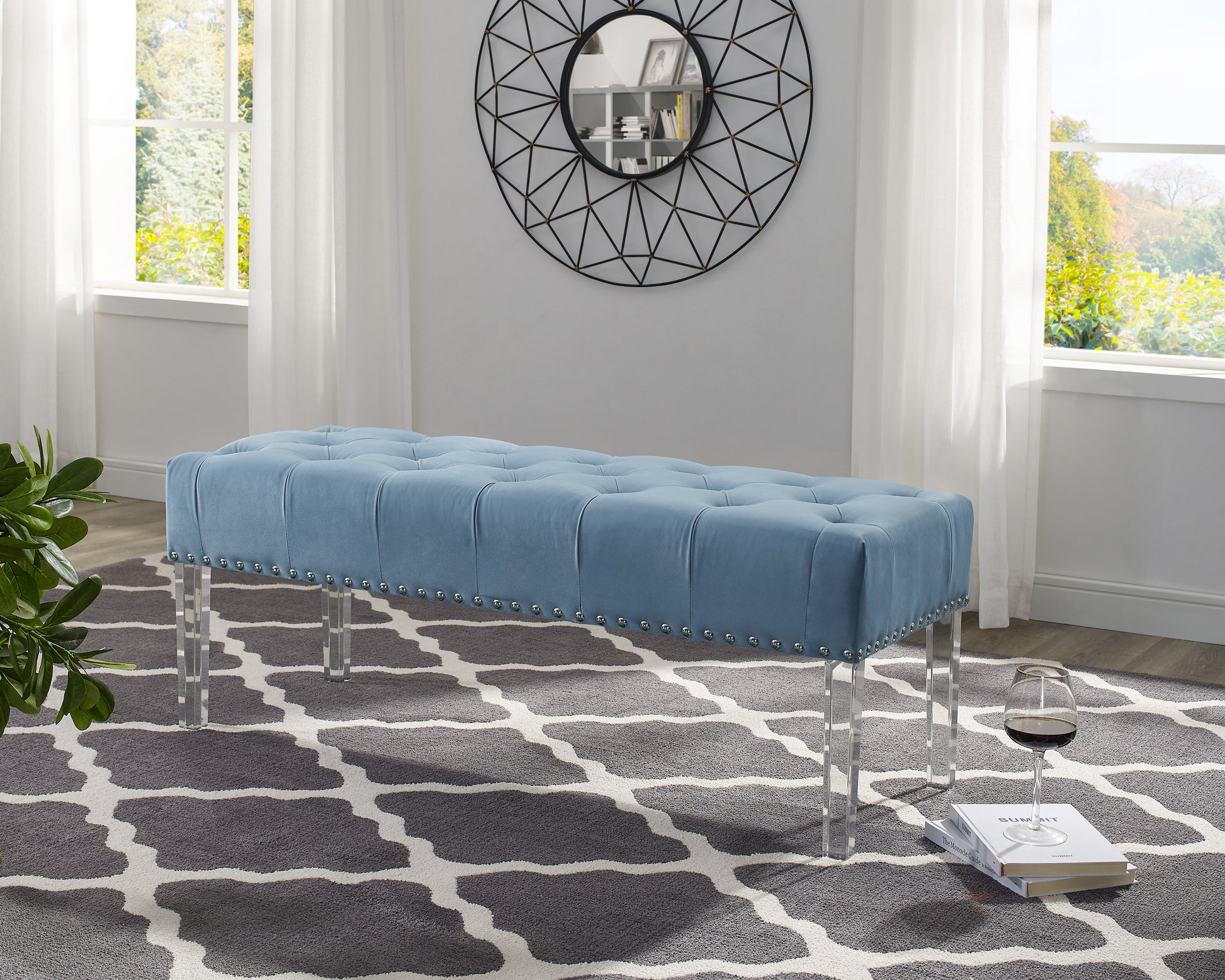Blue velvet tufted bench with silver nailhead trim and acrylic legs