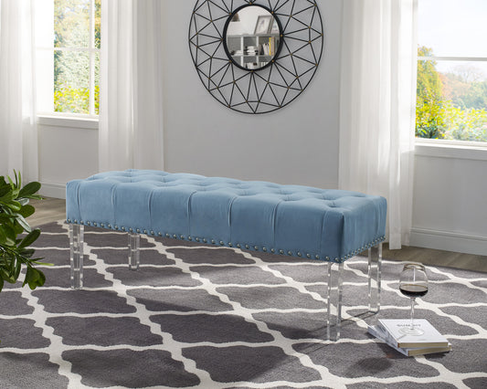 Blue velvet tufted bench with silver nailhead trim and acrylic legs
