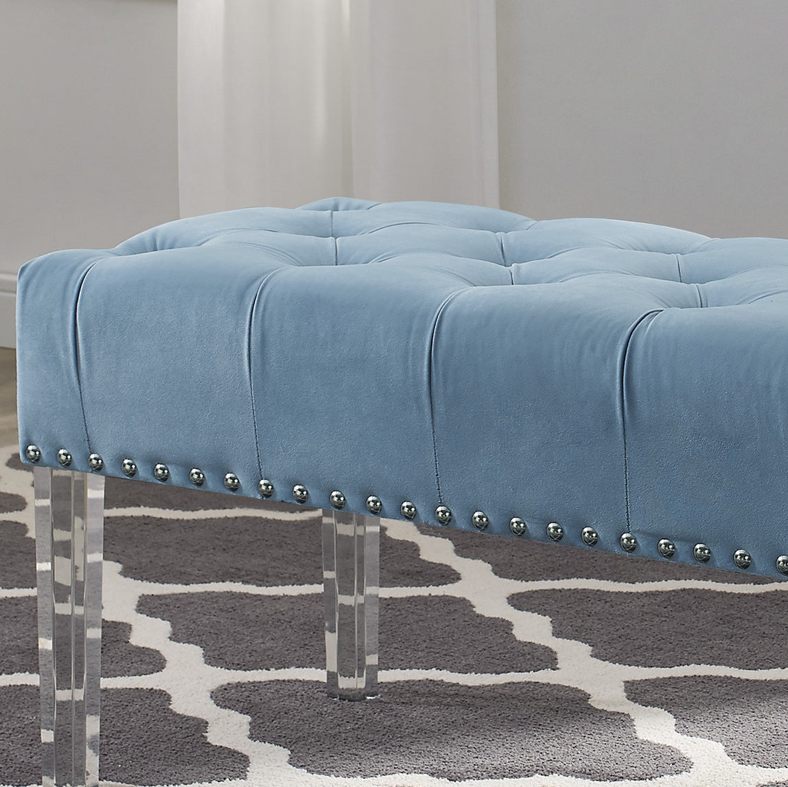 Light blue velvet tufted ottoman with silver nailhead trim and clear acrylic legs