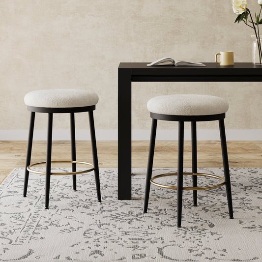 Cream boucle upholstered bar stool with black metal legs and gold footrest