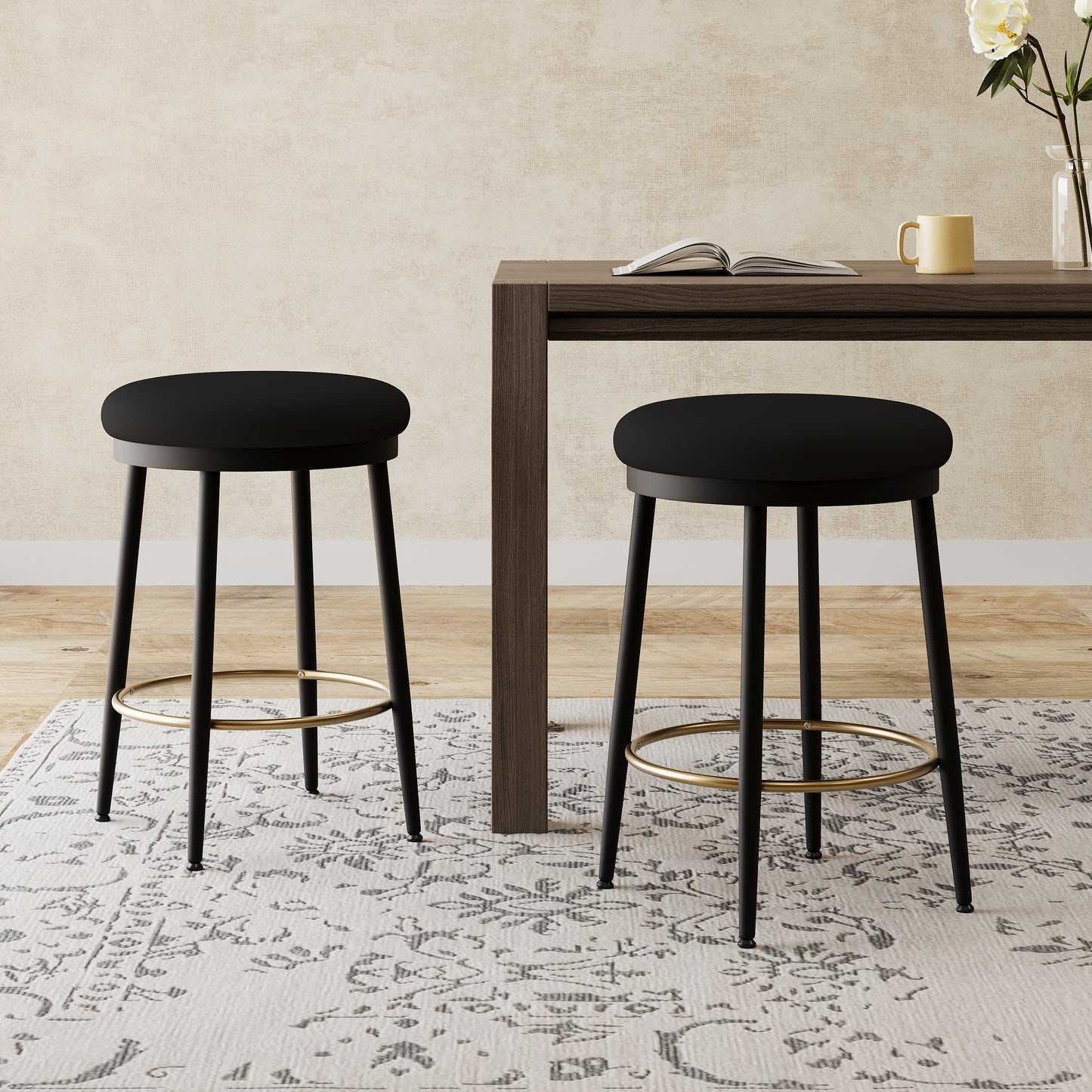 Black upholstered bar stool with gold footrest