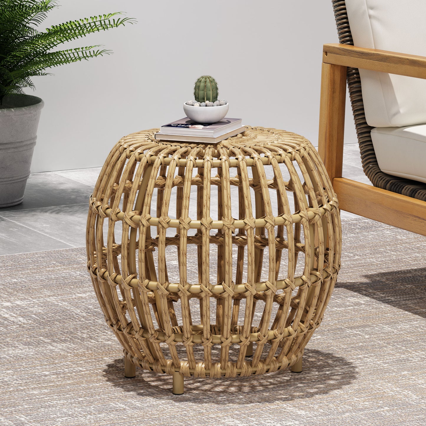 Natural rattan barrel accent table with woven detail and gold legs