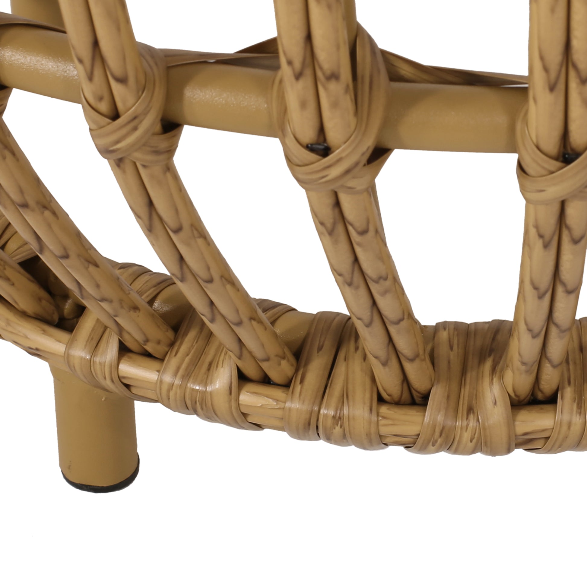 Closeup of woven rattan chair base with goldenbrown hue