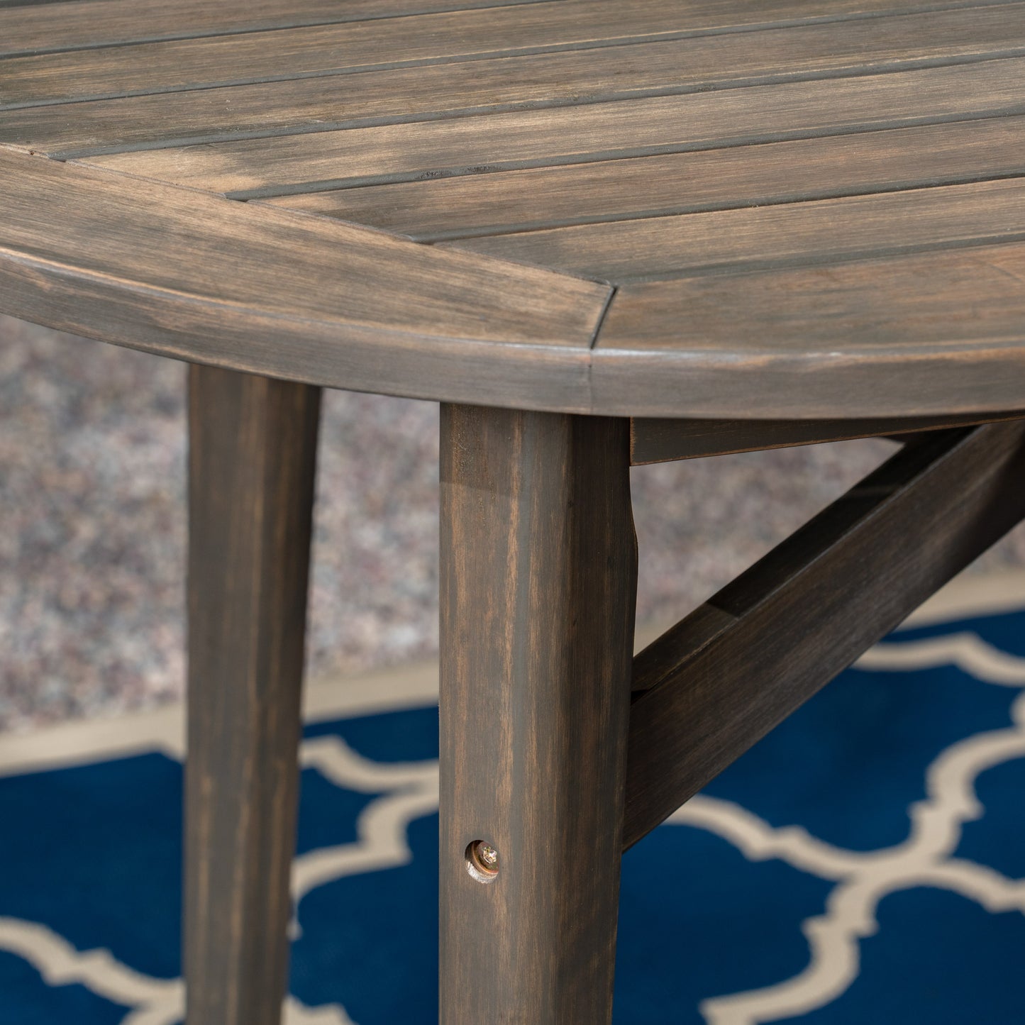 Closeup of dark wood planks on a round outdoor table