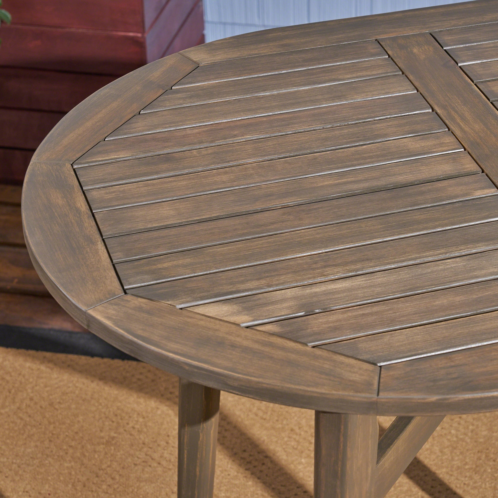 Rustic brown wood slatted round patio table top detail