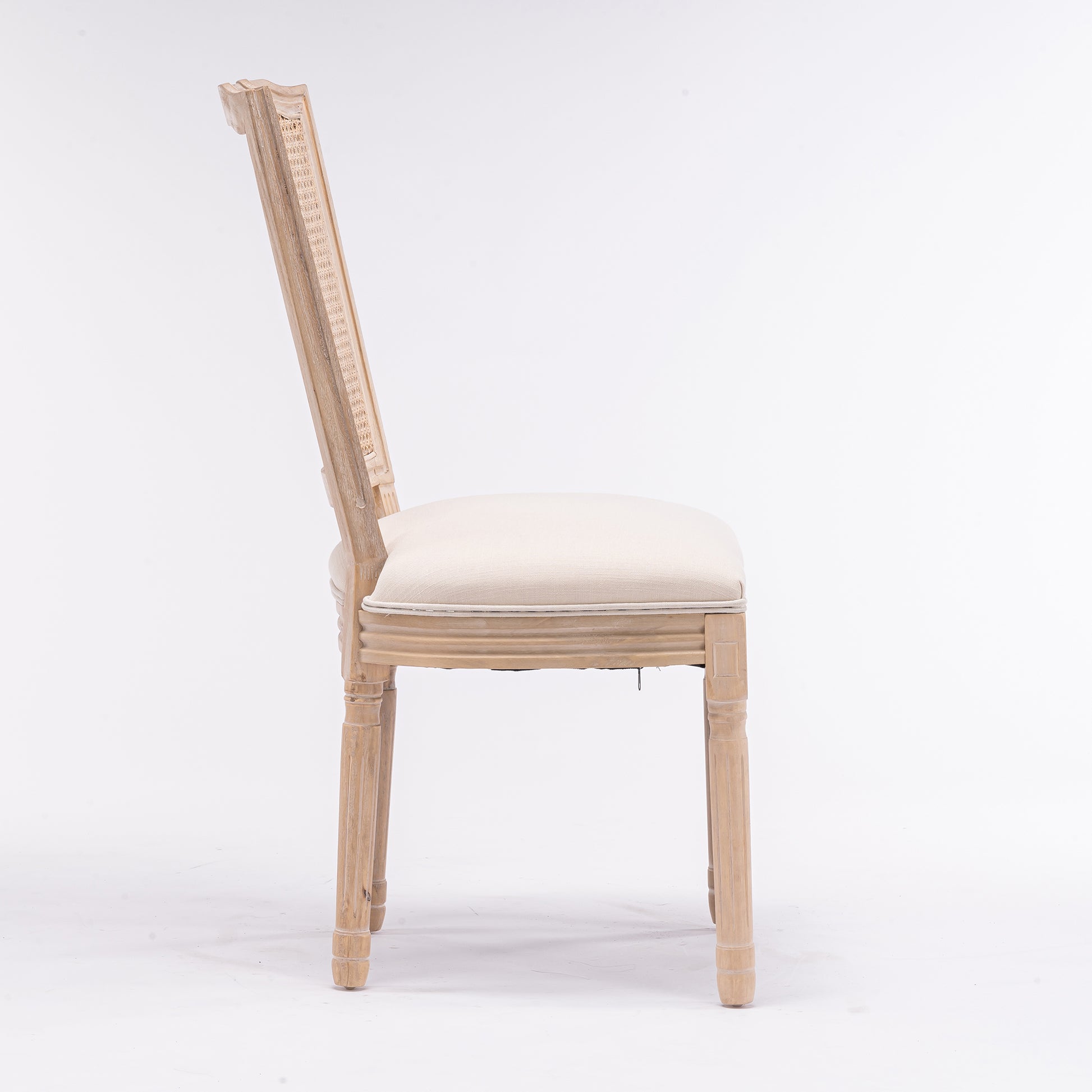 Light wood dining chair with cane back detail and cream upholstered seat