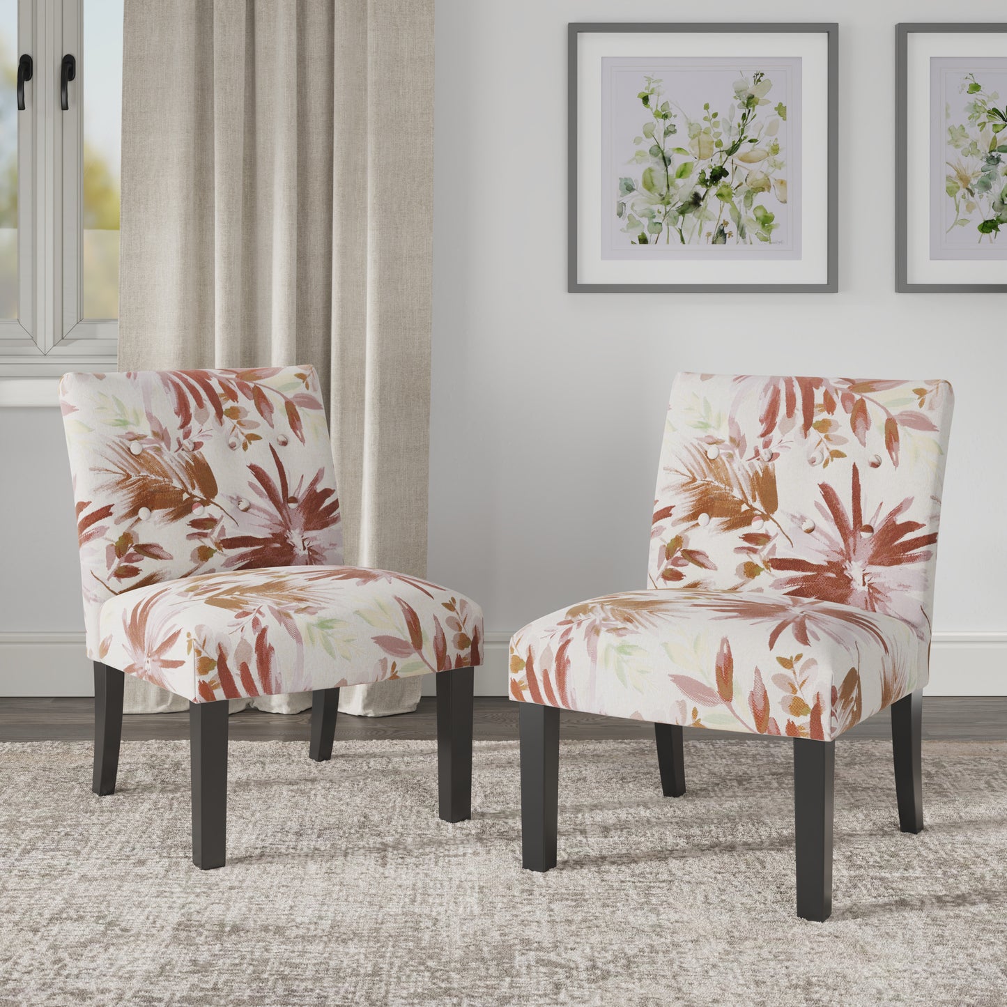 Two upholstered accent chairs with a tropical floral print in warm tones