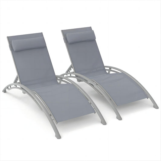 Two grey adjustable patio lounge chairs with padded headrests and curved frames