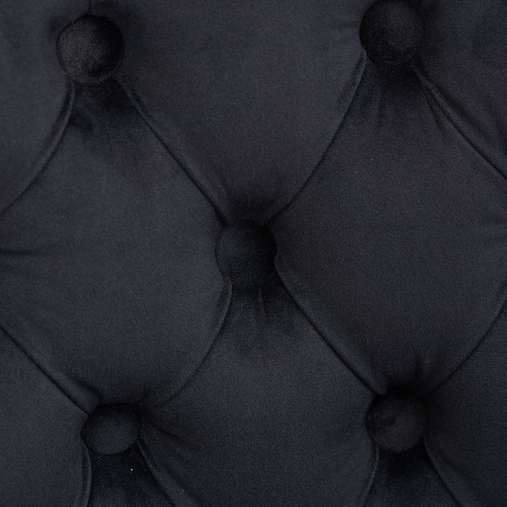 Black velvet upholstery with diamond tufting