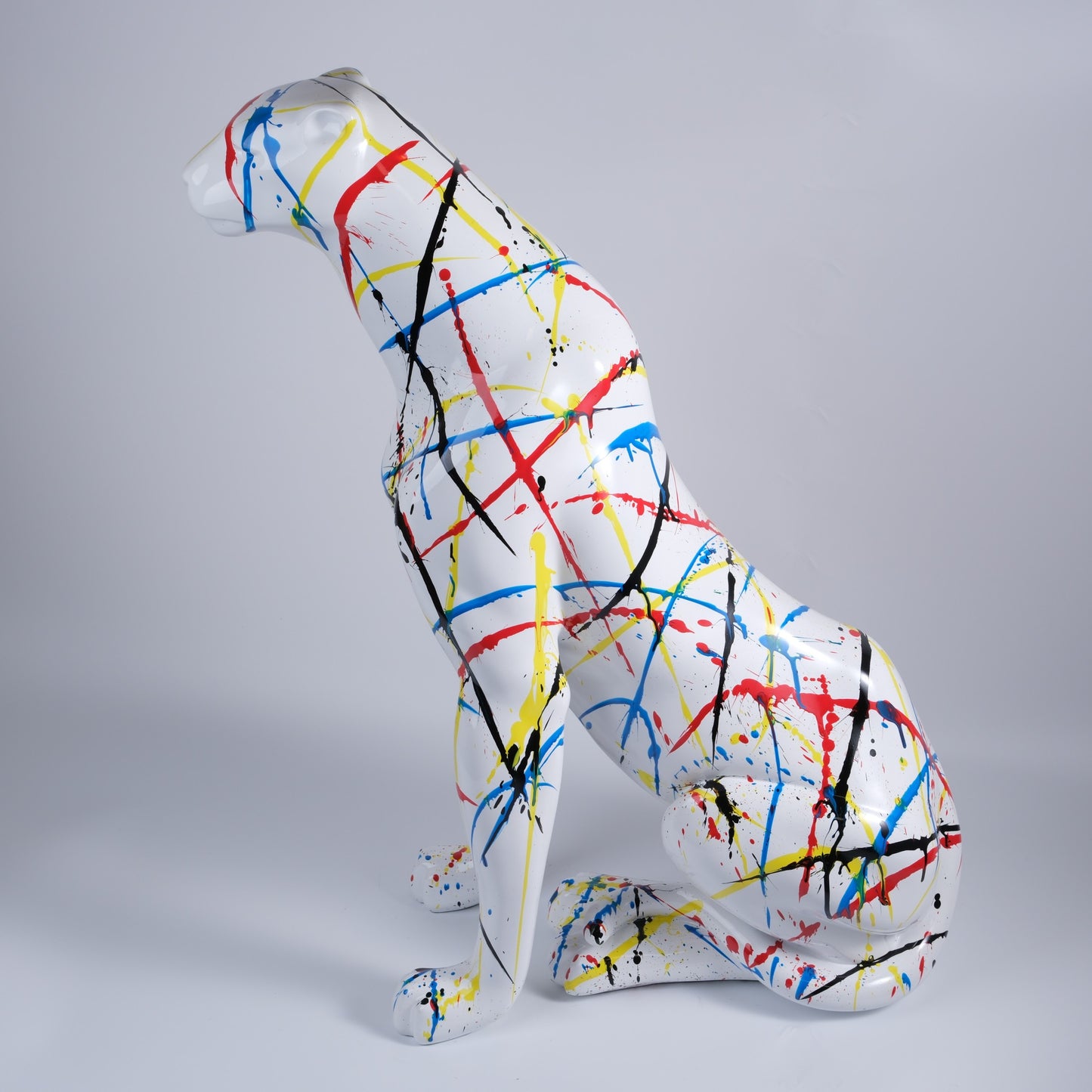 White cheetah statue with splatter paint design