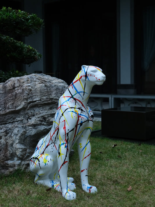White panther sculpture with abstract paint splatters modern garden art
