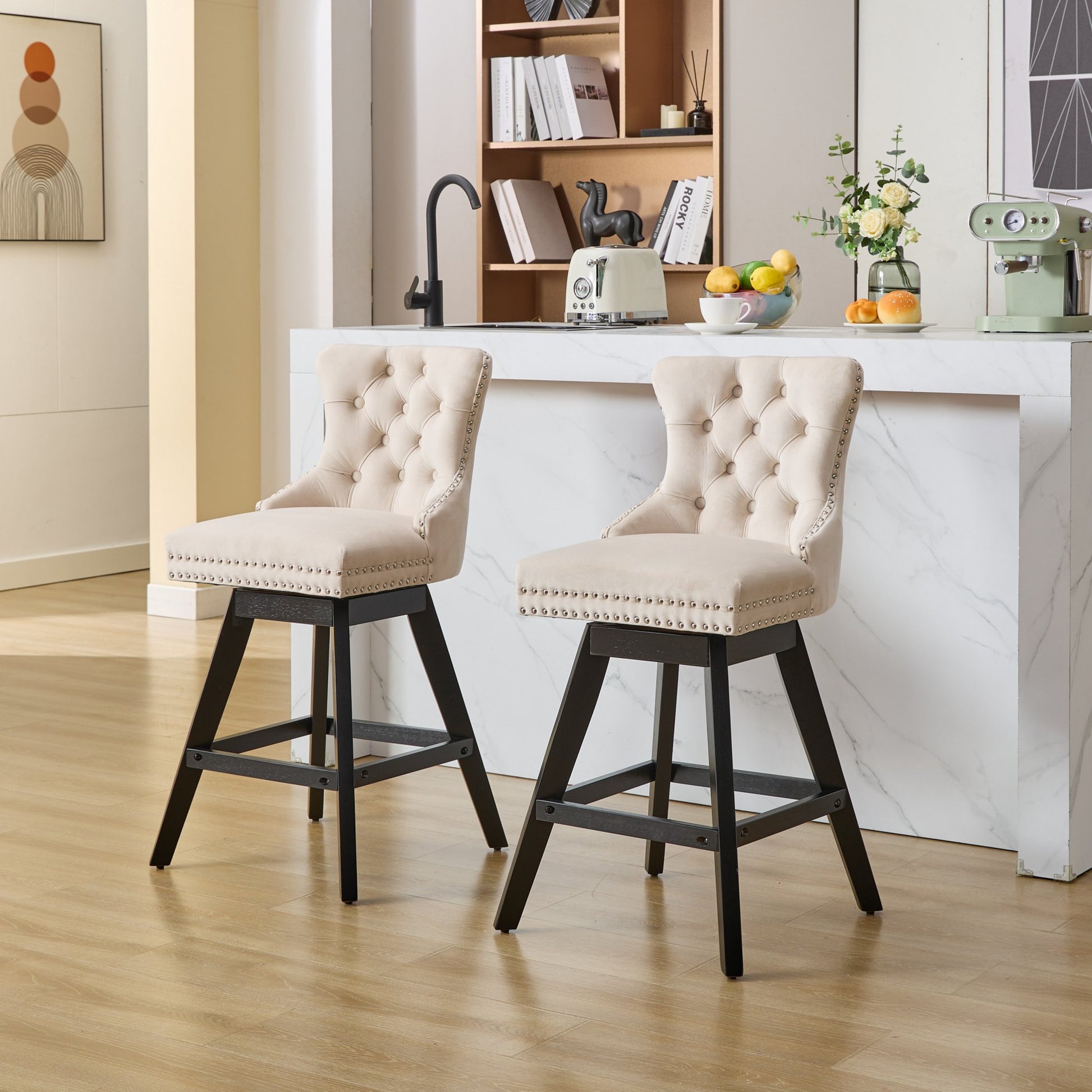 Tufted beige velvet swivel bar stool with silver nailhead trim and dark wood legs