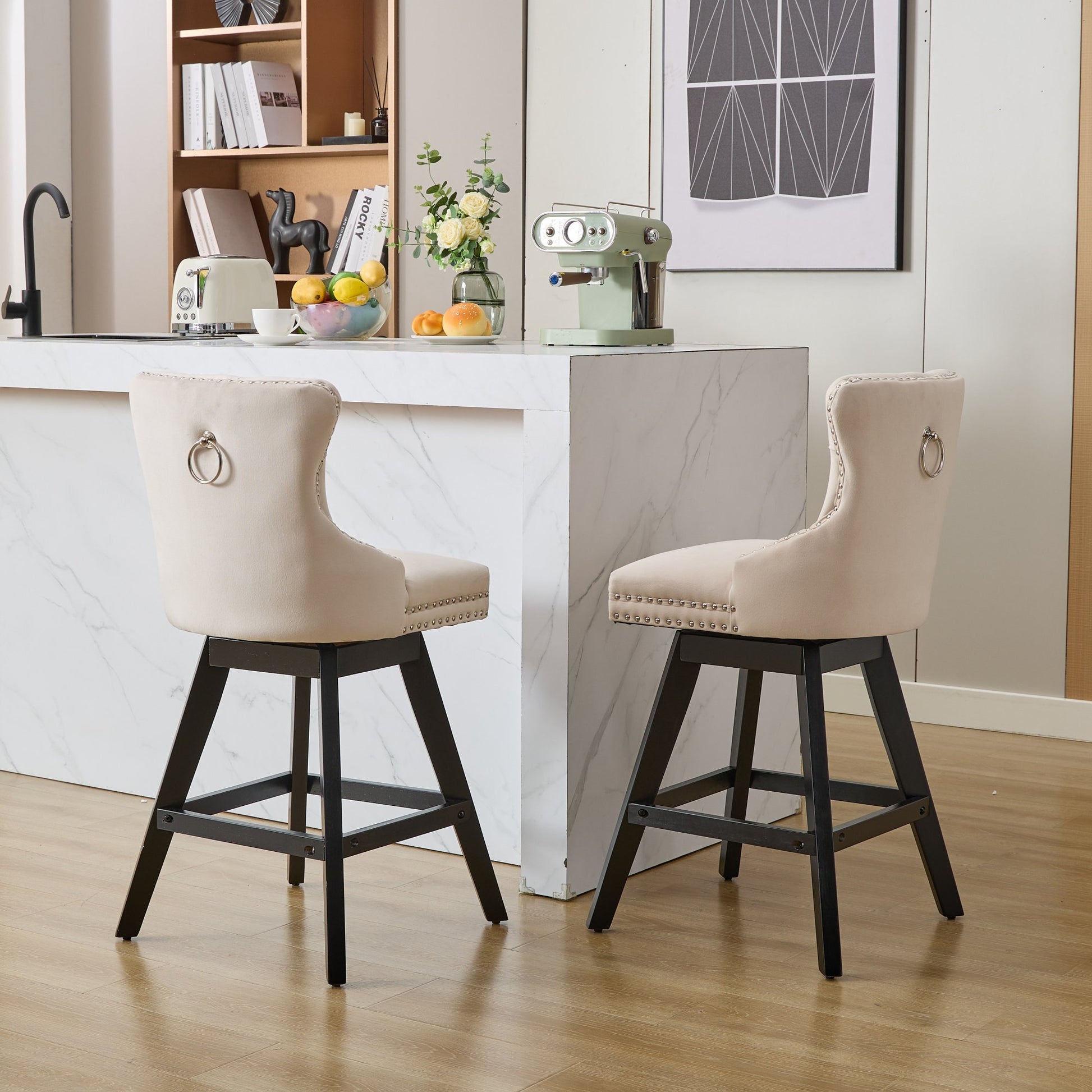 Upholstered beige bar stool with silver ring pull and nailhead trim
