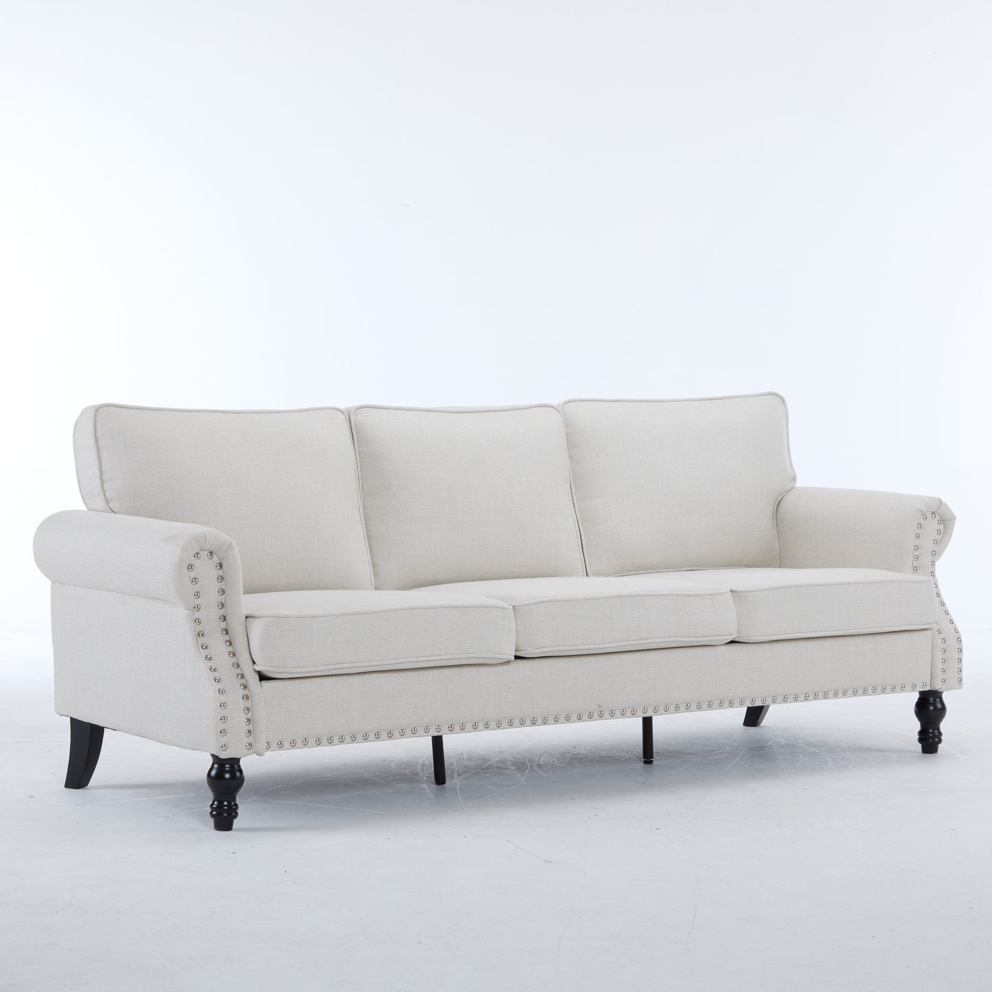 Elegant linen sofa in cream with nailhead trim and dark wood legs