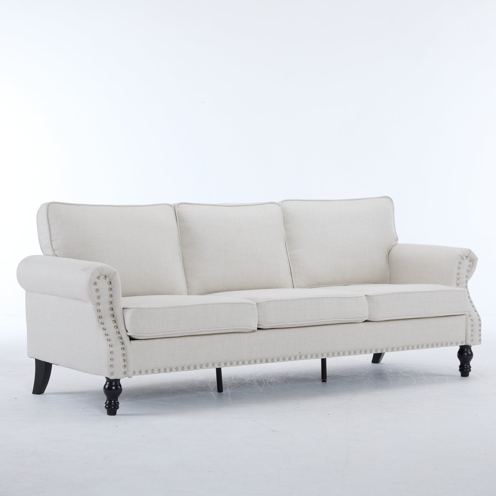 Elegant linen sofa in cream with nailhead trim and dark wood legs