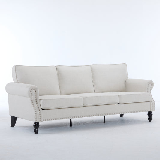 Elegant linen sofa in cream with nailhead trim and dark wood legs