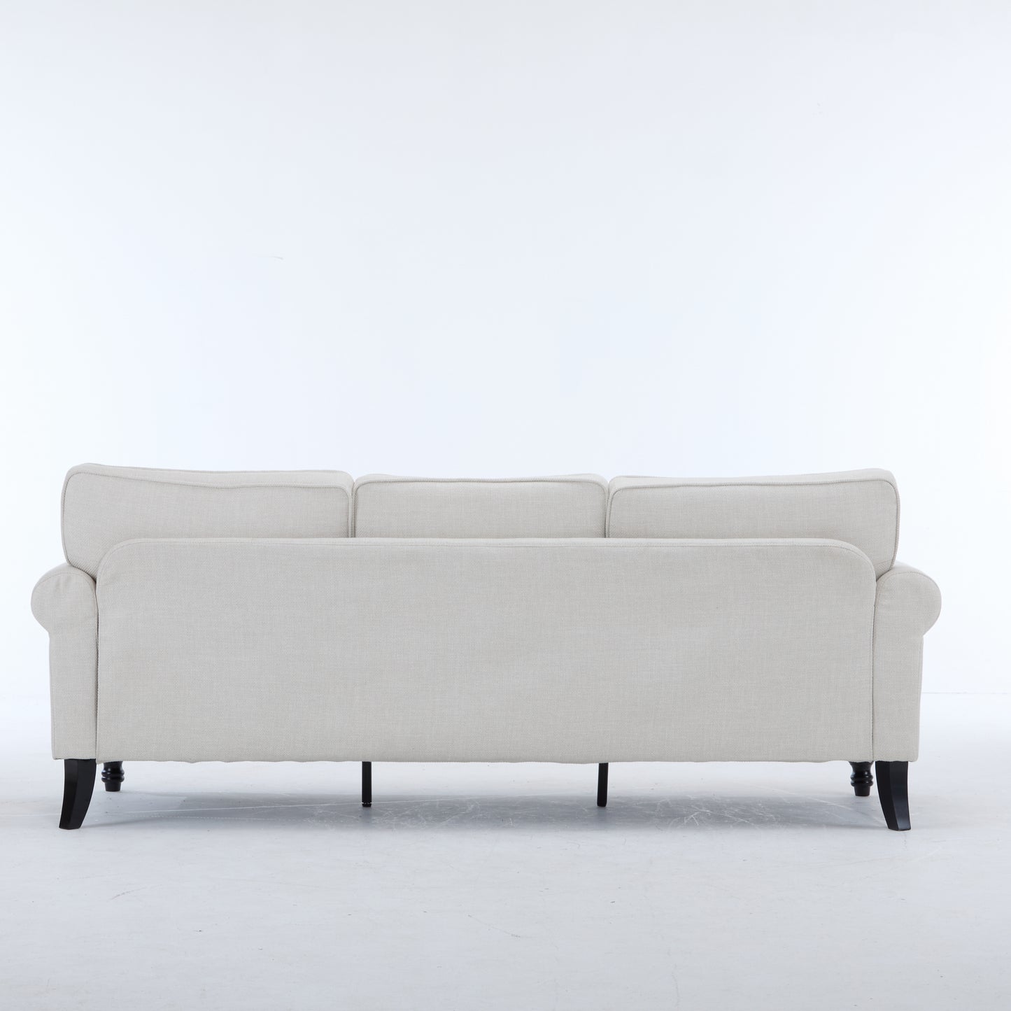 Light beige threeseater sofa with rolled arms and dark wooden legs
