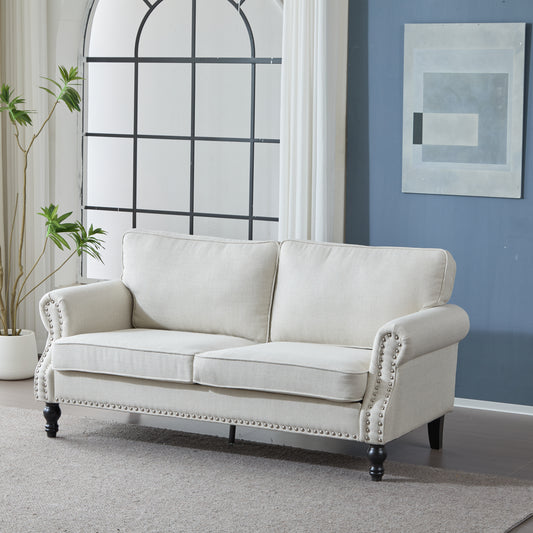 Cream upholstered sofa with nailhead trim and dark wooden legs