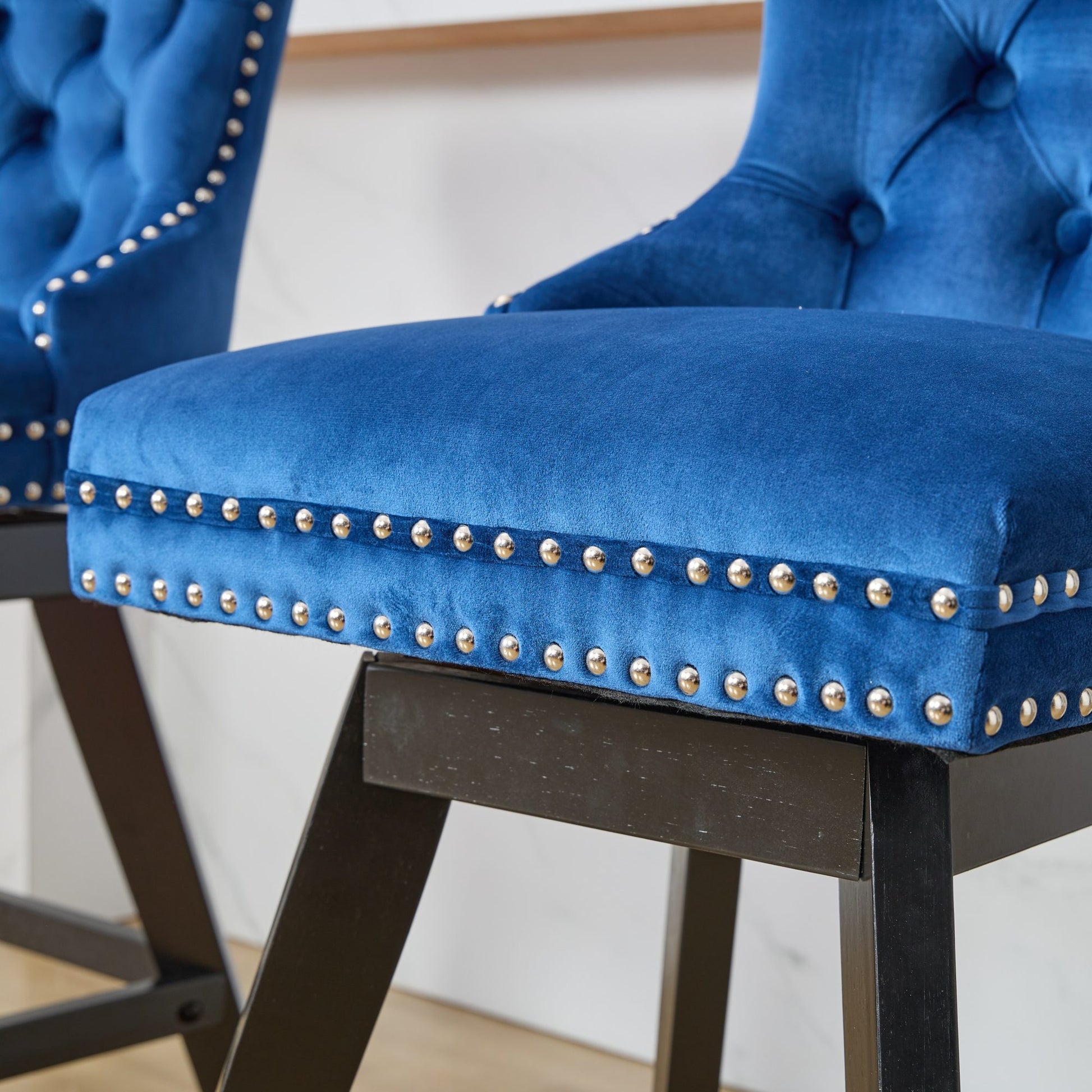 Royal blue velvet tufted bar stool with silver nailhead trim