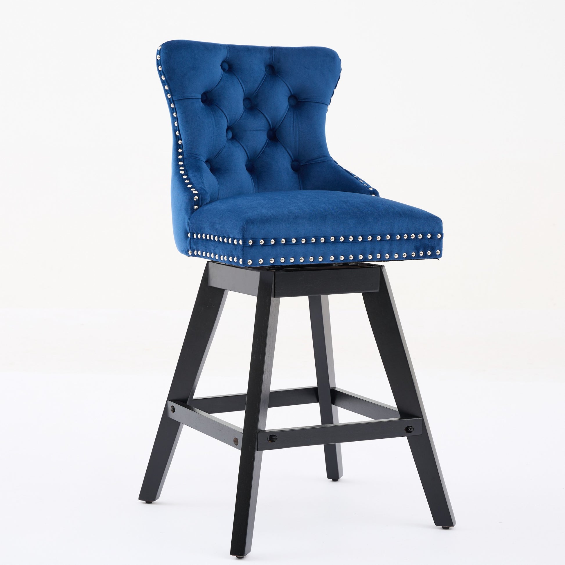 Deep blue velvet swivel bar stool with tufted back and silver nailhead trim