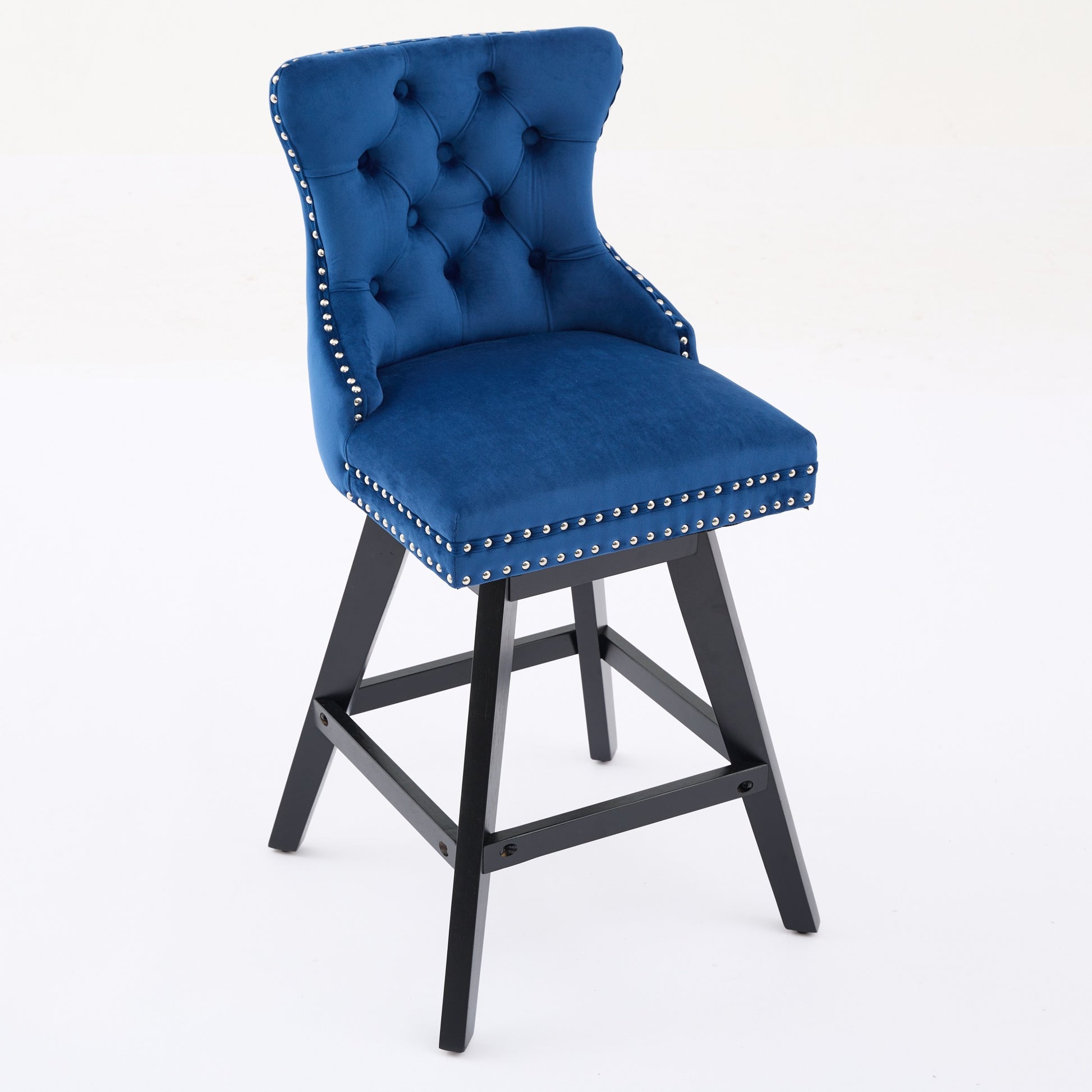 Blue velvet tufted swivel bar stool with silver nailhead trim and black wood legs